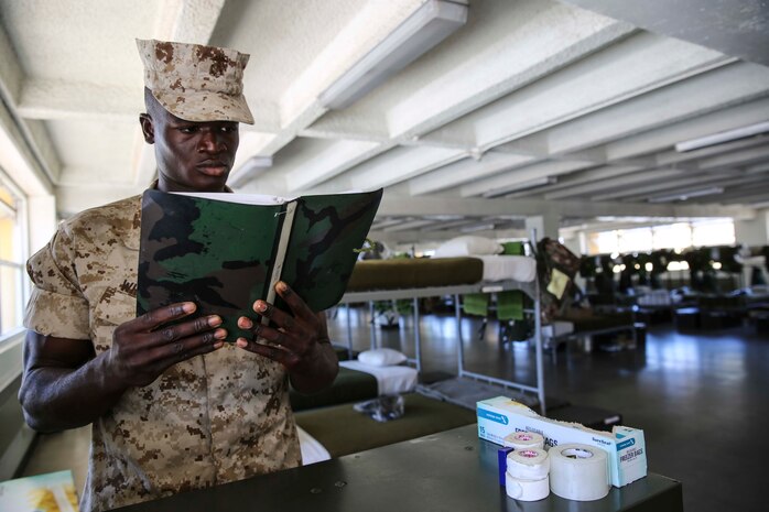 Pvt. Arthur G. Whisnant, Platoon 2166, Hotel Company, 2nd Recruit Training Battalion, studies Marine knowledge during squad bay duty at Marine Corps Recruit Depot San Diego, Calif., Aug. 11. Whisnant is a Freetown, Sierra Leon, native and was recruited out of Recruiting
Station Houston.