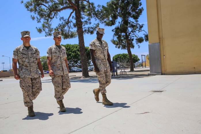 Pvt. Tristen C. Manikowski, left, Pfc. Donnie Tran, center, and Pvt.
Arthur G. Whisnant, right, all of Platoon 2166, walk to their afternoon
meal at Marine Corps Recruit Depot San Diego, Aug. 11.