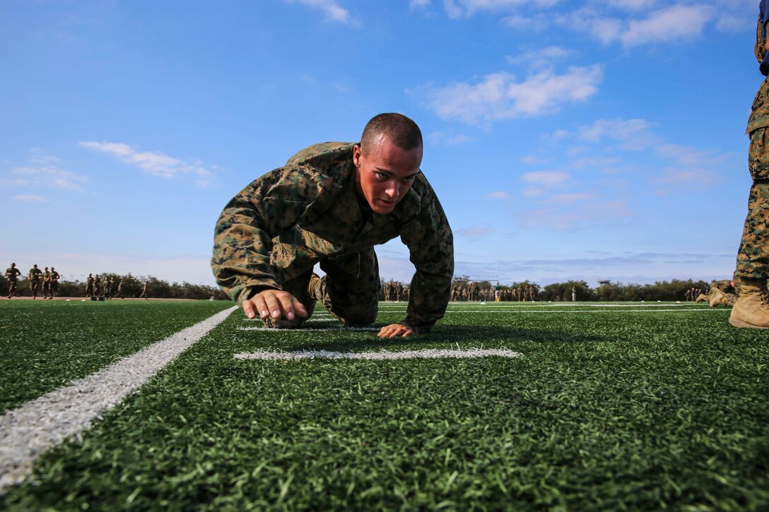 A recruit from Mike Company, 3rd Recruit Training Battalion, high crawls during the maneuver under fire portion of the Combat Fitness Test at Marine Corps Recruit Depot San Diego, Calif., Aug. 7. The maneuver under fire is one of three exercises included in the CFT, and scores are kept on their military record for promotional purposes in the Fleet Marine Force.