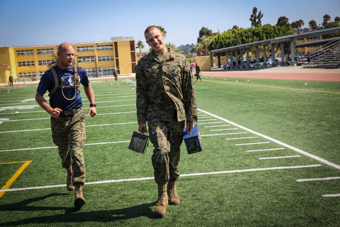A recruit from Mike Company, 3rd Recruit Training Battalion, carries
ammunition cans during the maneuver under fire portion of
the Combat Fitness Test at Marine Corps Recruit Depot San Diego,
Calif., Aug. 7. The maneuver under fire requires a low crawl, high
crawl, fireman’s carry and the transportation of ammunition cans.