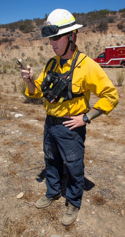 Chief Josh Allen, assistant fire chief with the Miramar Fire Department, checks his bearings before the wildland firefighting exercise with 3rd Marine Aircraft Wing aviators aboard Marine Corps Air Station Miramar, Calif., Aug. 14. The training was designed to build a communication based foundation for firefighters and aviators to build on in case of future fires aboard the air station or in the San Diego community.