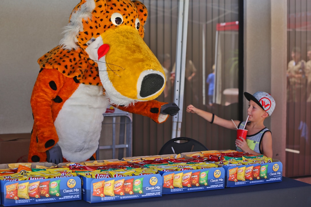 Landon, five, befriends a mascot during a vendor fair hosted by Marine Corps Community Services, at Camp Pendleton, Calif., Aug. 15. Thirty vendors participated in the two-hour event, which was held to enhance sales for the Country Store and raise awareness about its services. The store is in Camp Pendleton's Mainside area and hosts a number of restaurants, a beverage shop, a grocery store and tailoring services. (U.S. Marine Corps photo by Lance Cpl. Shaltiel Dominguez/ Released)