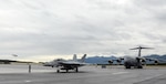 JOINT BASE ELMENDORF-RICHARDSON, Alaska (Aug. 8, 2014) - An F-18 Hornet returns from a mission, an F-22 Raptor takes to the skies, and a C-17 Globemaster prepares for a mission during Red Flag-Alaska 14-3. Red Flag- Alaska is a joint/coalition exercise designed to help militaries from all over the world hone their skills in simulated combat. 140808-F-DE377-004
