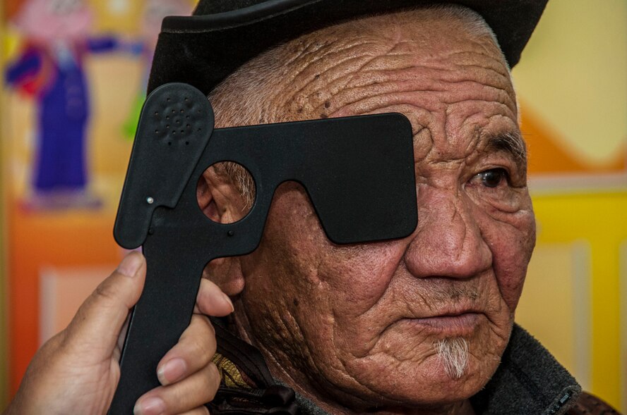A Mongolian citizen receives an eye exam as part of Pacific Angel 14-4 in Bulgan, Mongolia, Aug. 15, 2014.PACANGEL supports U.S. Pacific Command’s capacity-building efforts by partnering with other governments, non-governmental agencies and multilateral militaries in the respective region to provide medical, dental, optometry, and engineering assistance to their citizens. (U.S. Air Force photo by SSgt. William Banton/Released)