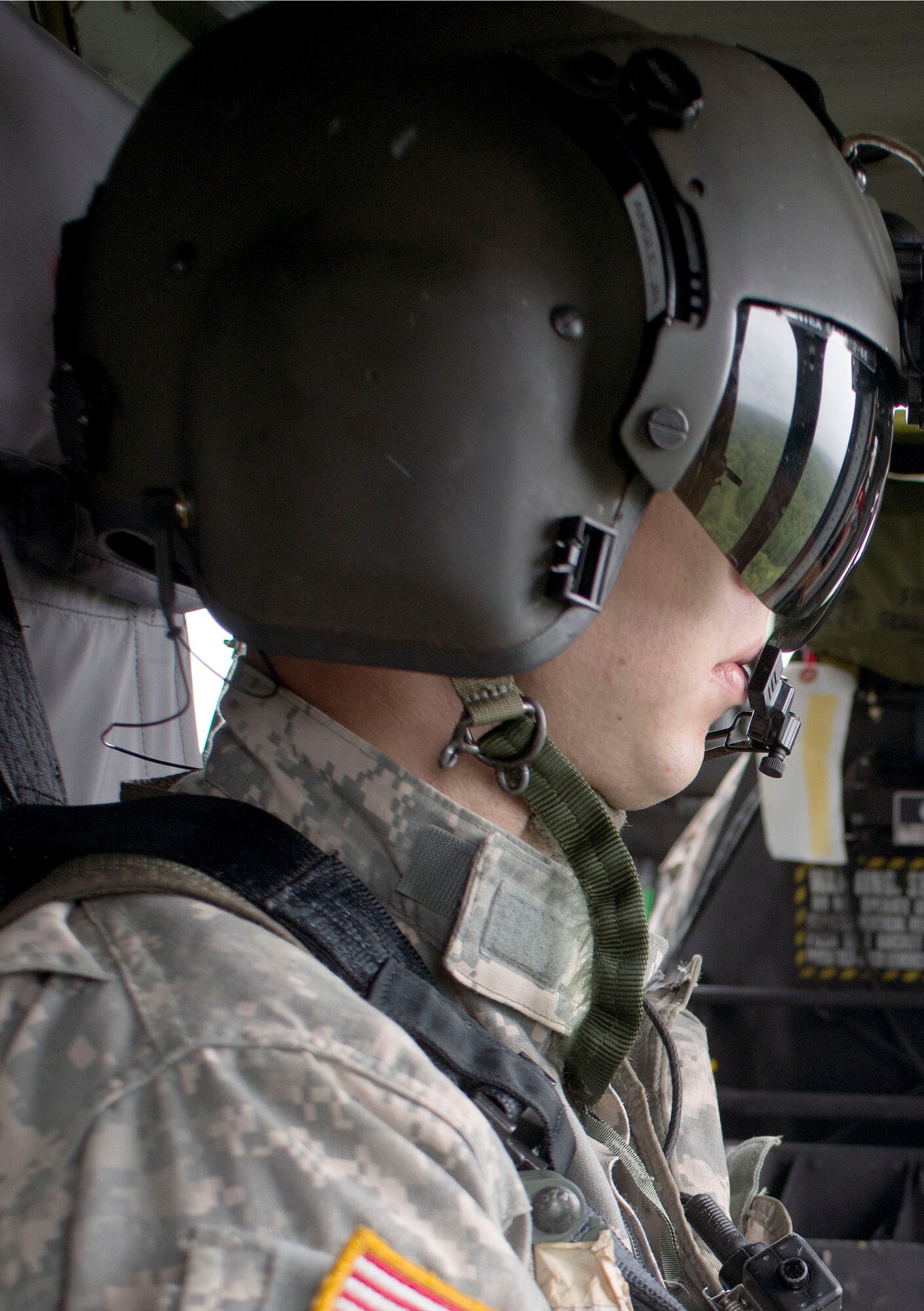 Spc. Jeffery Angle, New Jersey Army National Guard crew chief, looks out the window of a UH-60 over the Joint Base McGuire-Dix-Lakehurst training range Aug. 13, 2014 during the immersion tour of the U.S. Air Force Expeditionary Center for Lt. Gen. Carlton D. Everhart II, 18th Air Force commander, and Maj. Gen. Warren Berry, Air Mobility Command director of logistics. JBMDL has over 31,000 acres available for training like the ongoing Exercise Eagle Flag. Eagle Flag is a U.S. Air Force Expeditionary Center directed exercise that tests contingency response units’ ability to quickly establish aerial operations, provide security, track cargo and personnel, and move supplies in an immersive scenario. (US Air Force Photo/Master Sgt. Christopher Bergstrom)