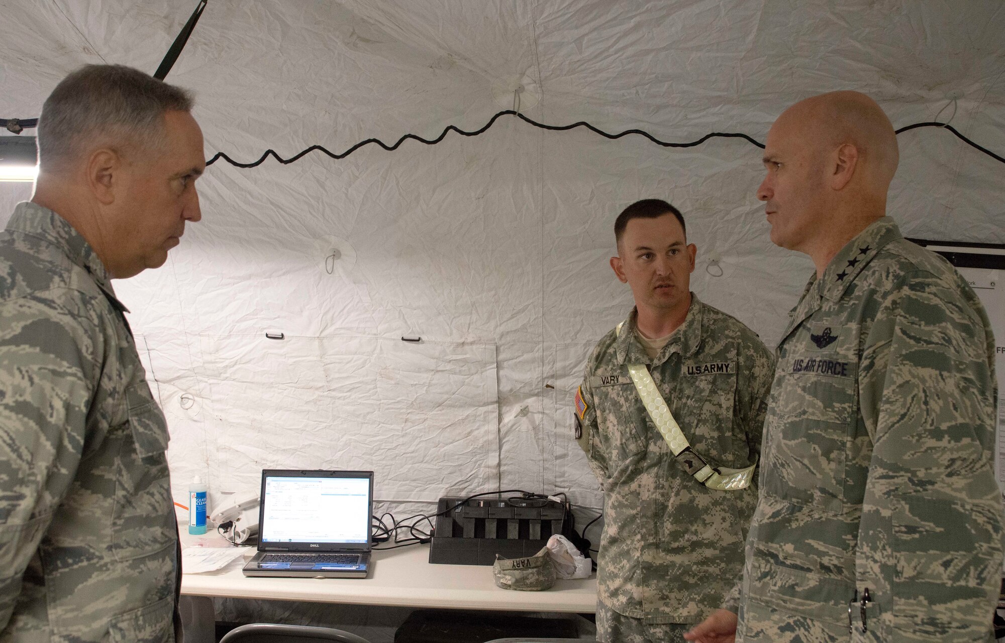 Maj. Gen. Rick Martin, U.S. Air Force Expeditionary Center commander, looks on as Sgt. Travis Vary, 587 Transportation Brigade movement noncommissioned officer, briefs Lt. Gen. Carlton D. Everhart II, 18th Air Force commander, on his role in Exercise Eagle Flag. Exercise Eagle Flag is Air Force’s only flag-level exercise designed to prepare Airmen for future contingency operations by testing the span of mobility operation and the entire library of expeditionary skills and providing realistic host nation interaction experience. Everhart was at JB MDL for an orientation of the Expeditionary Center.   (US Air Force Photo/Master Sgt. Christopher Bergstrom)