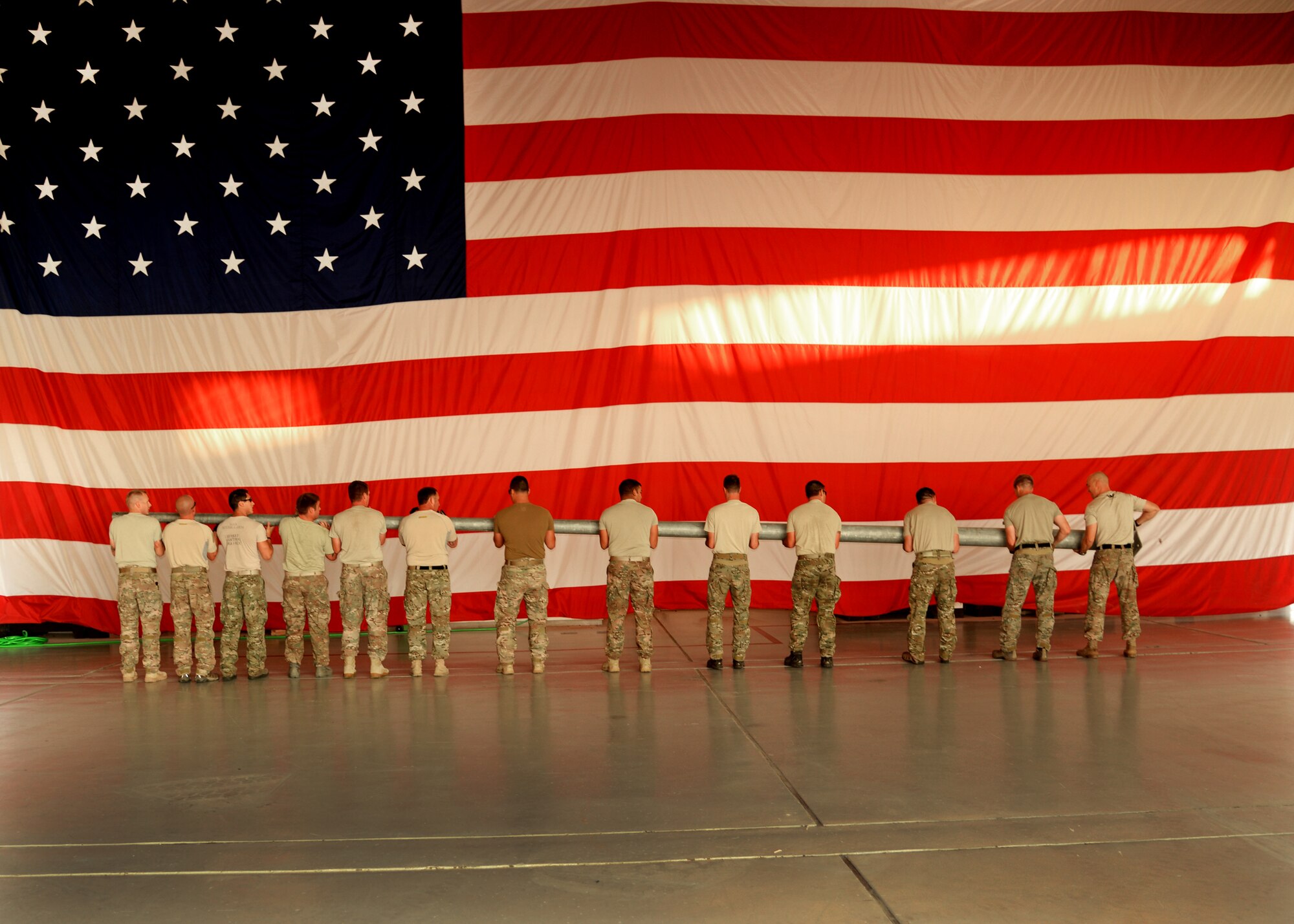 Members of the 26th Special Tactics Squadron carry a flagpole across the flightline at Cannon Air Force Base, N.M., Aug. 5, 2014. The flag pole was flown in from Afghanistan and will be erected at Cannon to honor Air Commandos who have paid the ultimate sacrifice. (U.S. Air Force Photo/Airman 1st Class Chip Slack)