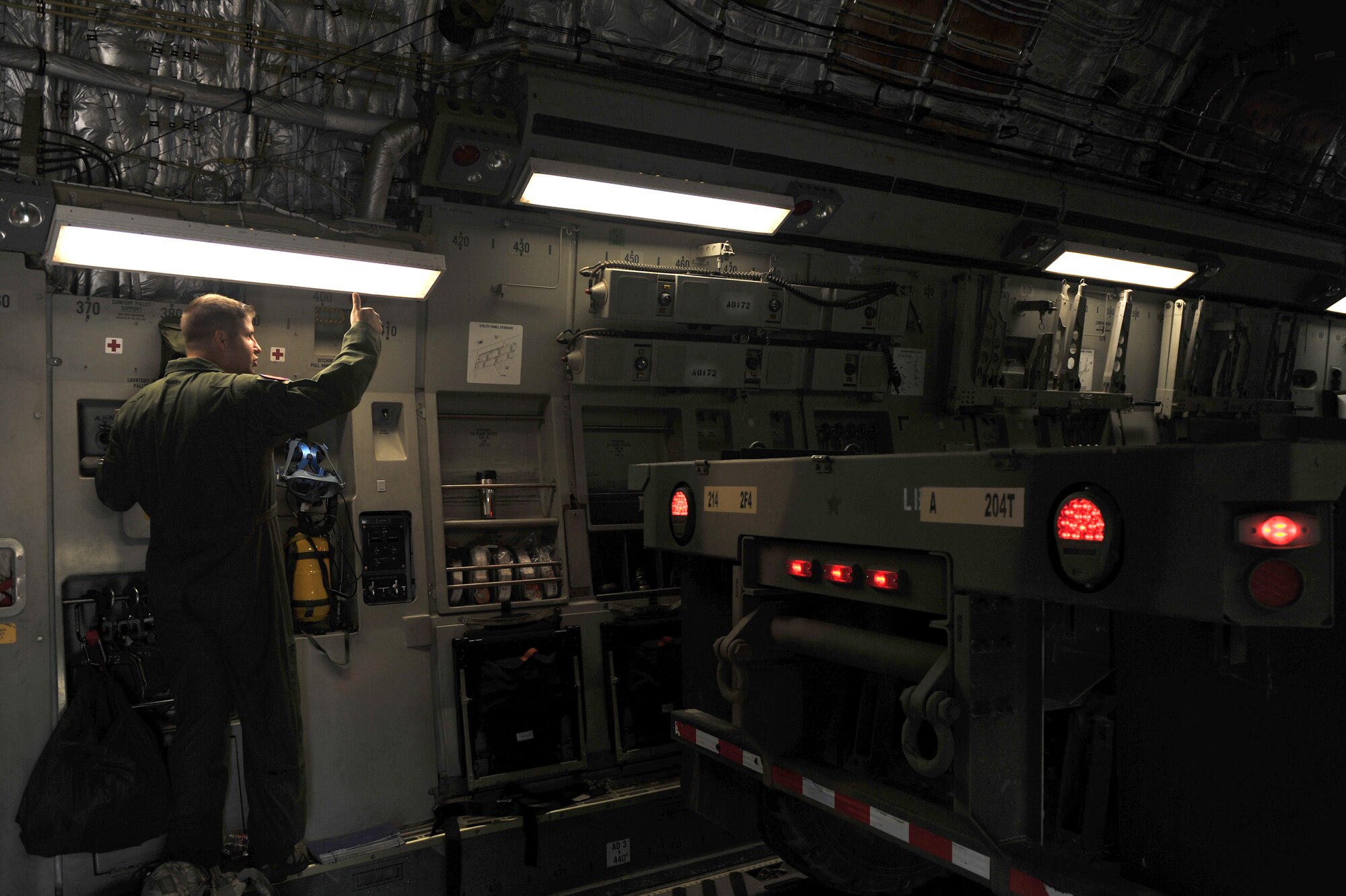 ALTUS AIR FORCE BASE, Okla. – U.S. Air Force Tech. Sgt. Jack Metzger, 58th Airlift Squadron loadmaster, guides a U.S. Army cargo truck onto a U.S. Air Force C-17 Globemaster III cargo aircraft during a joint emergency deployment readiness exercise between the 58th AS and U.S. Army 1-14th Field Artillery Regiment from Fort Sill, Okla. Aug. 14, 2014. The training allowed the units to practice loading U.S. Army M142 High Mobility Artillery Rocket Systems and other accompanying military equipment to simulate real-world combat operations. (U.S. Air Force photo by Senior Airman Dillon Davis/Released)