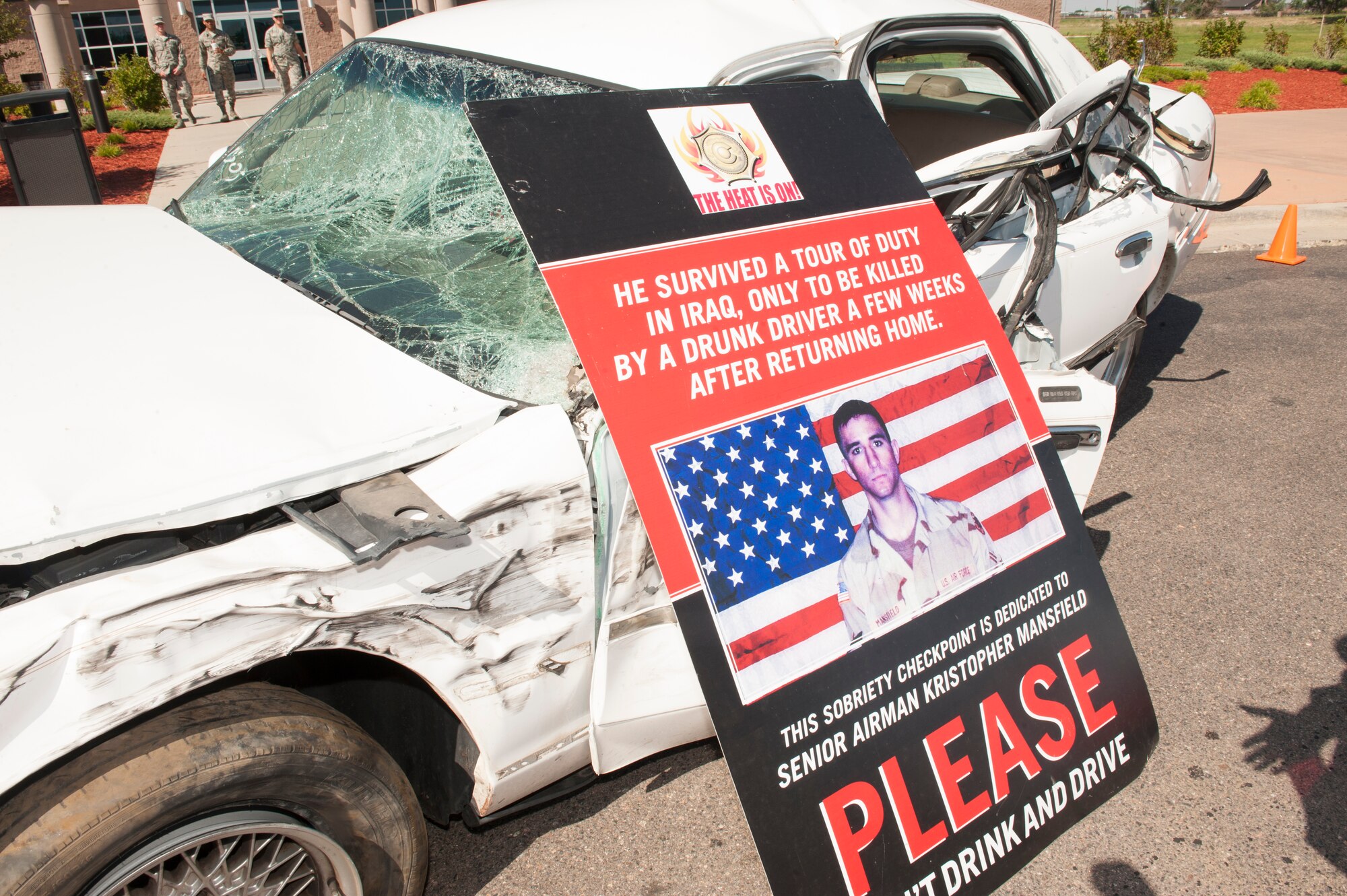 A crushed car and a stark reminder of the dangers of drinking and driving were placed outside the base fitness center during the Team Buckley Safety Day Aug. 12, 2014, on Buckley Air Force Base, Colo. Safety day consisted of presentations and stories designed to raise awareness of the dangers of making poor decisions on the road. (U.S. Air Force photo by Airman 1st Class Samantha Saulsbury/Released)