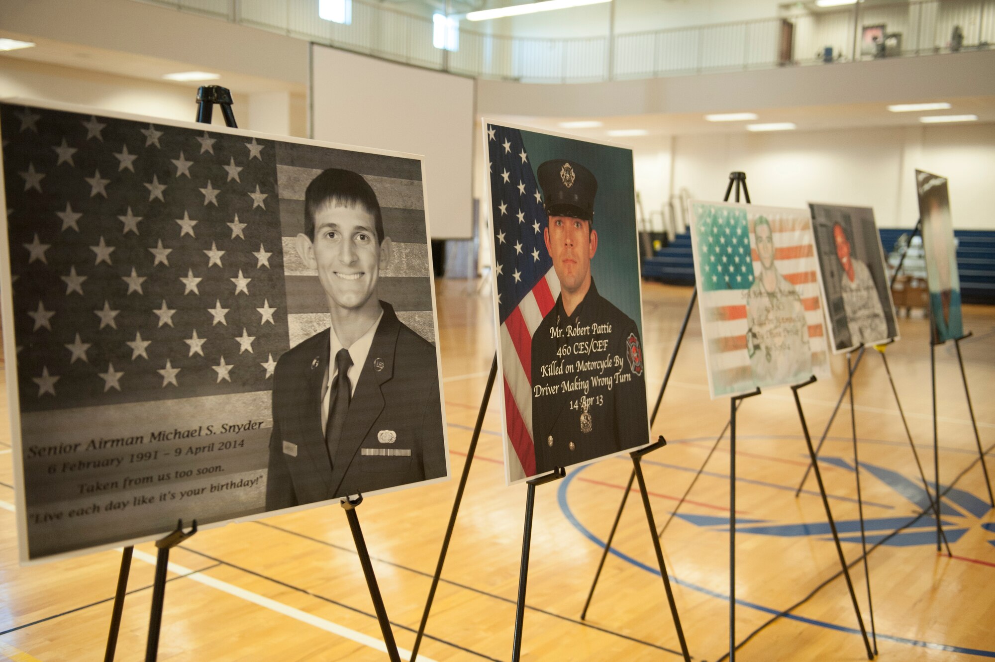 Photos of Team Buckley members lost to motorcycle, drunk driving and other accidents are displayed during the Team Buckley Safety Day Aug. 12, 2014, at the base fitness center on Buckley Air Force Base, Colo. Safety day consisted of presentations and stories designed to raise awareness of the dangers of making poor decisions on the road. (U.S. Air Force photo by Airman 1st Class Samantha Saulsbury/Released)
