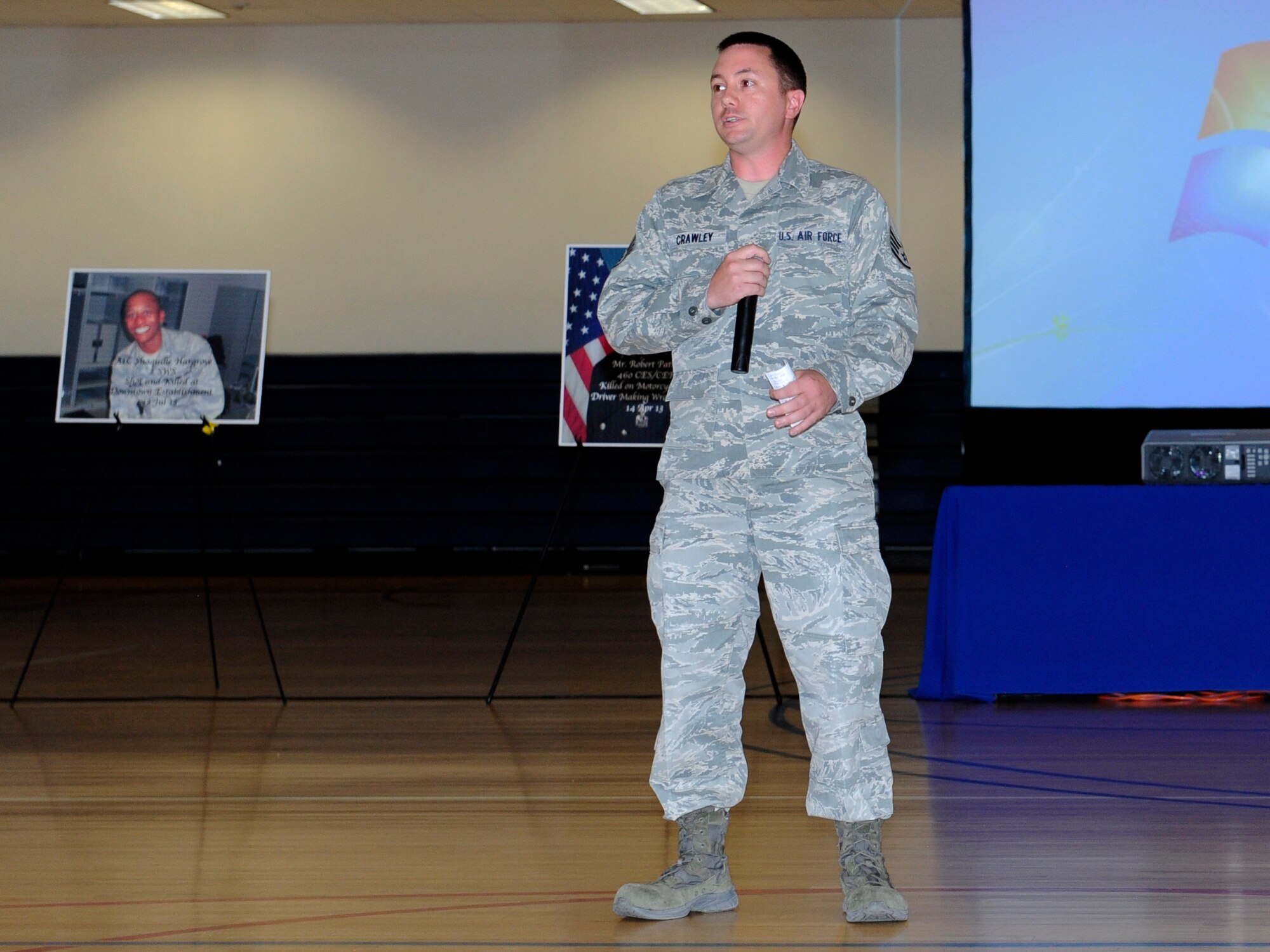 Staff Sgt. James Crawley, 460th Space Communications Squadron, recounts his motorcycle accident for Team Buckley members during the Team Buckley Safety Day Aug. 12, 2014, at the base fitness center on Buckley Air Force Base, Colo. Safety day consisted of presentations and stories designed to raise awareness of the dangers of making poor decisions on the road. (U.S. Air Force photo by Airman 1st Class Samantha Saulsbury/Released)