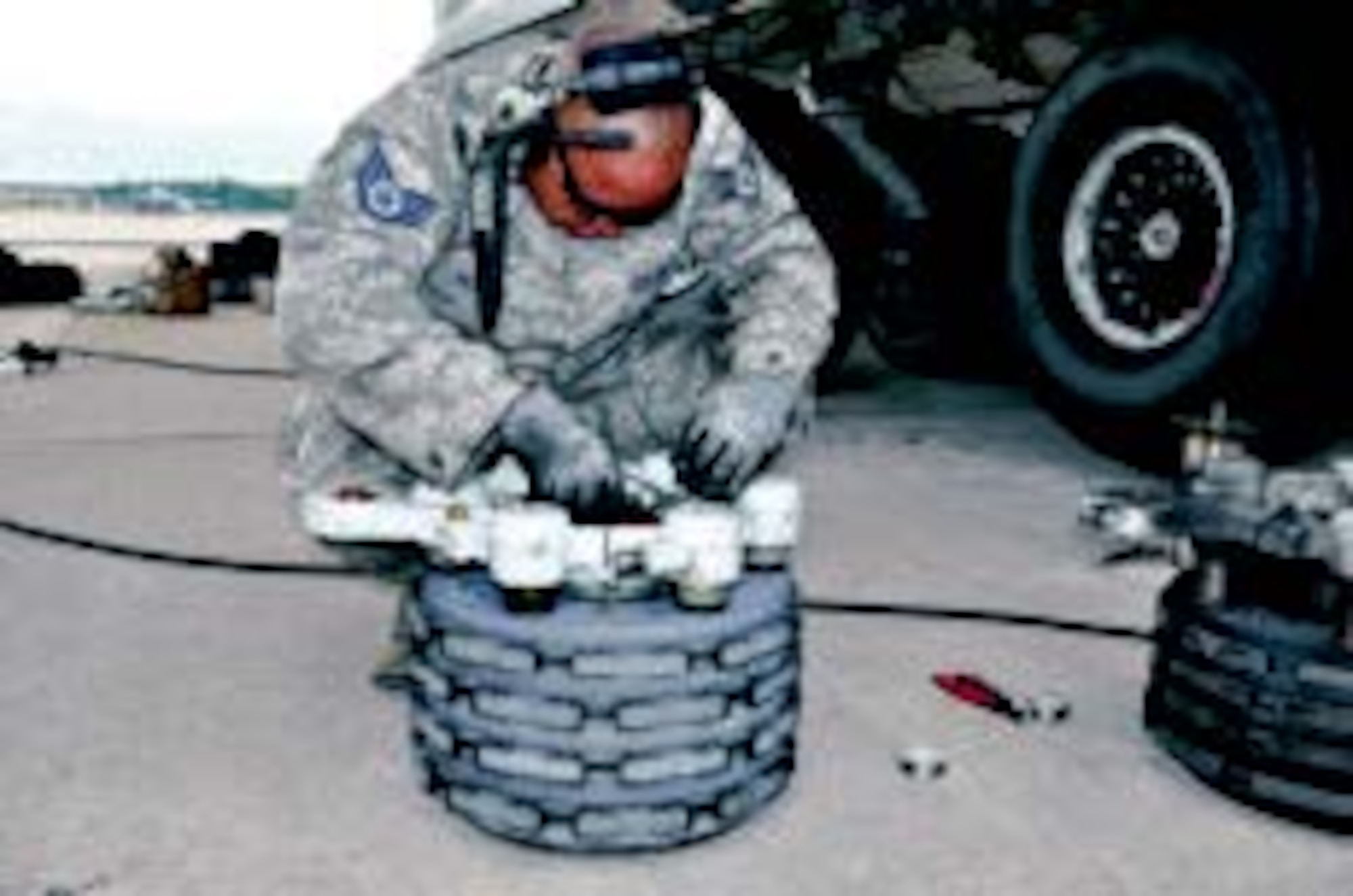 Staff Sgt. Jacob Nelson, 445th Aircraft Maintenance Squadron crew chief, works on a C-17 brake safety wire during a brake replacement. The worn brake can be seen at right. (Air Force photos by Capt. Elizabeth Caraway)
