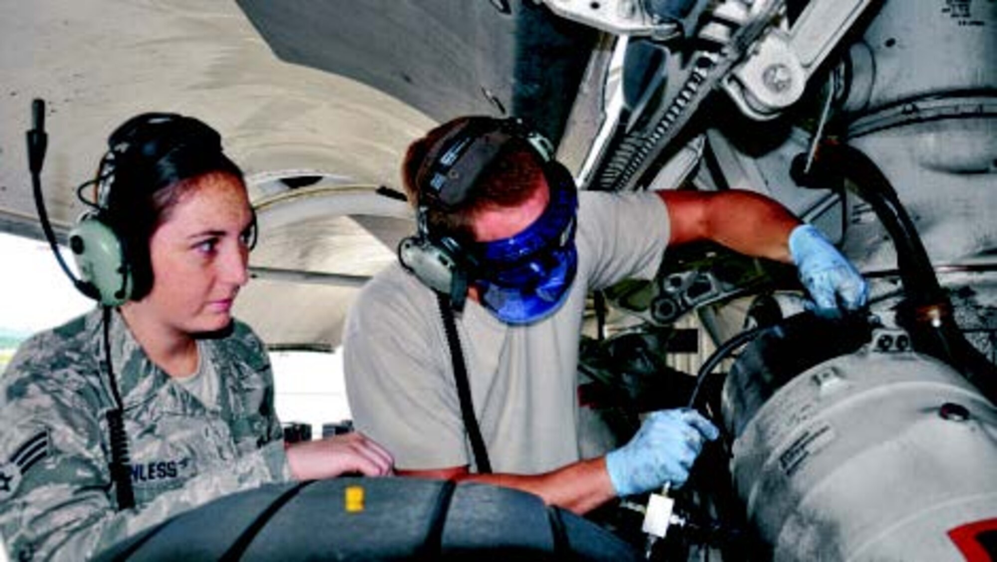 Staff Sgt. Steve Billingsly, 445th Aircraft Maintenance Squadron C-17 crew chief, explains the process of removing a brake assembly to Senior Airman Shea Wanless, avionics specialist. (Air Force photos by Capt. Elizabeth Caraway)