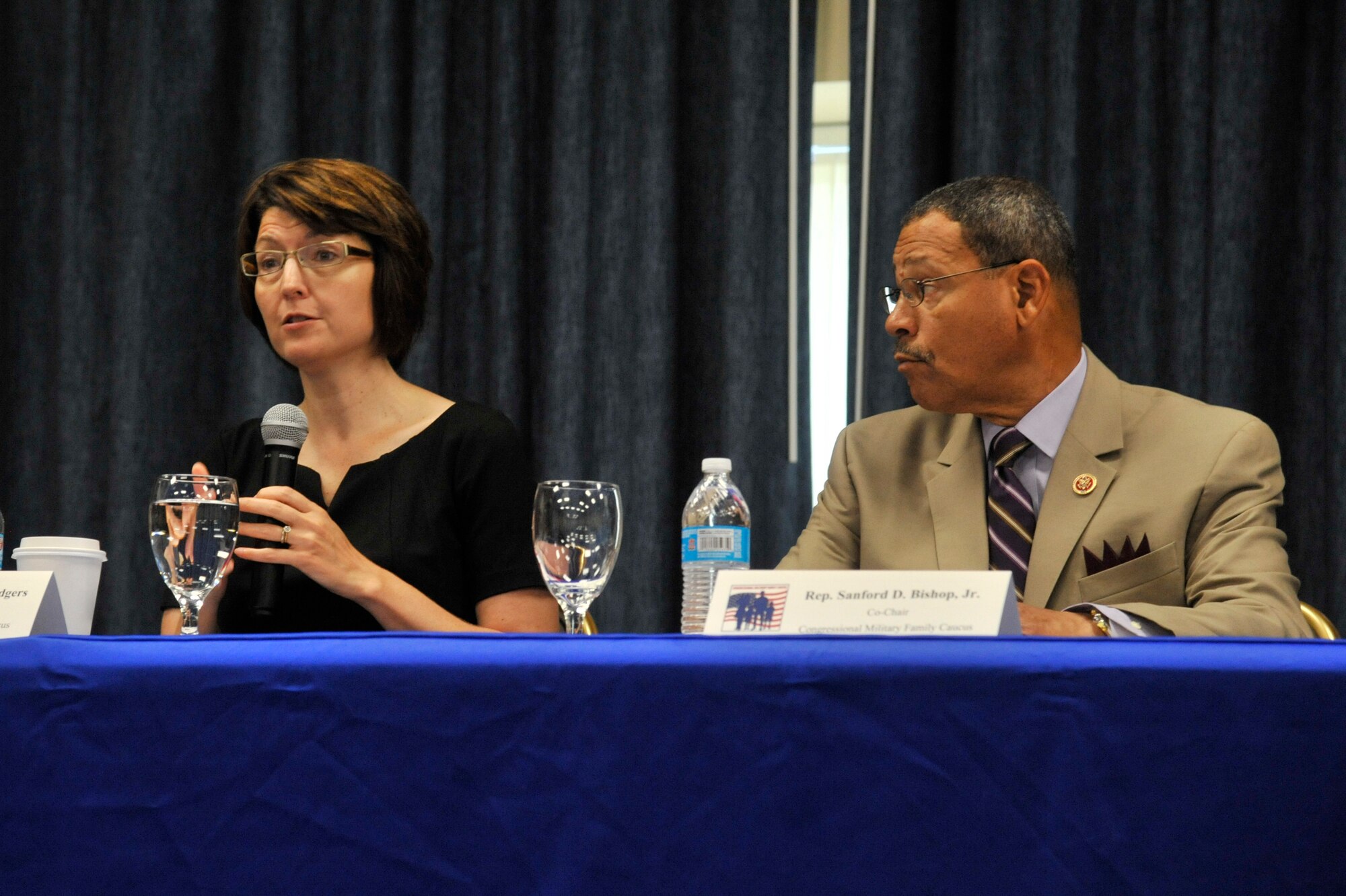 Washington Rep. Cathy McMorris-Rodgers and Georgia Rep. Sanford Bishop speak to audience members during the opening discussion of the Fairchild Military Family Summit at Fairchild Air Force Base, Washington, Aug. 14, 2014. McMorris-Rodgers and Bishop co-founded the Congressional Military Family Caucus in 2009, giving military families the opportunity to discuss various issues with congressional representatives. (U.S. Air Force photo by Senior Airman Mary O'Dell/Released)