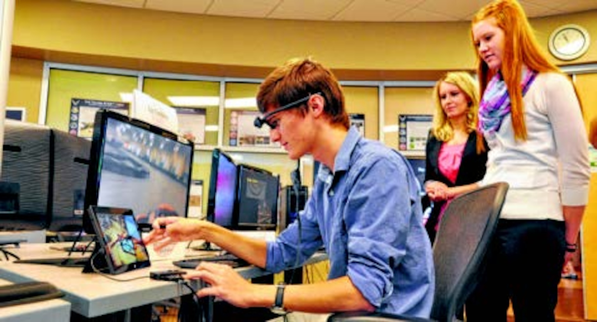 Air Force Research Laboratory Gaming Research Integration for Learning Lab interns Kenneth Howe, Macy Fraylick and Lizzie Adams demonstrate eye tracking technology Aug. 7 at the Wright Brothers Institute’s Tec^Edge Innovation and Collaboration Center in Dayton. (Air Force photo by Michele Eaton)