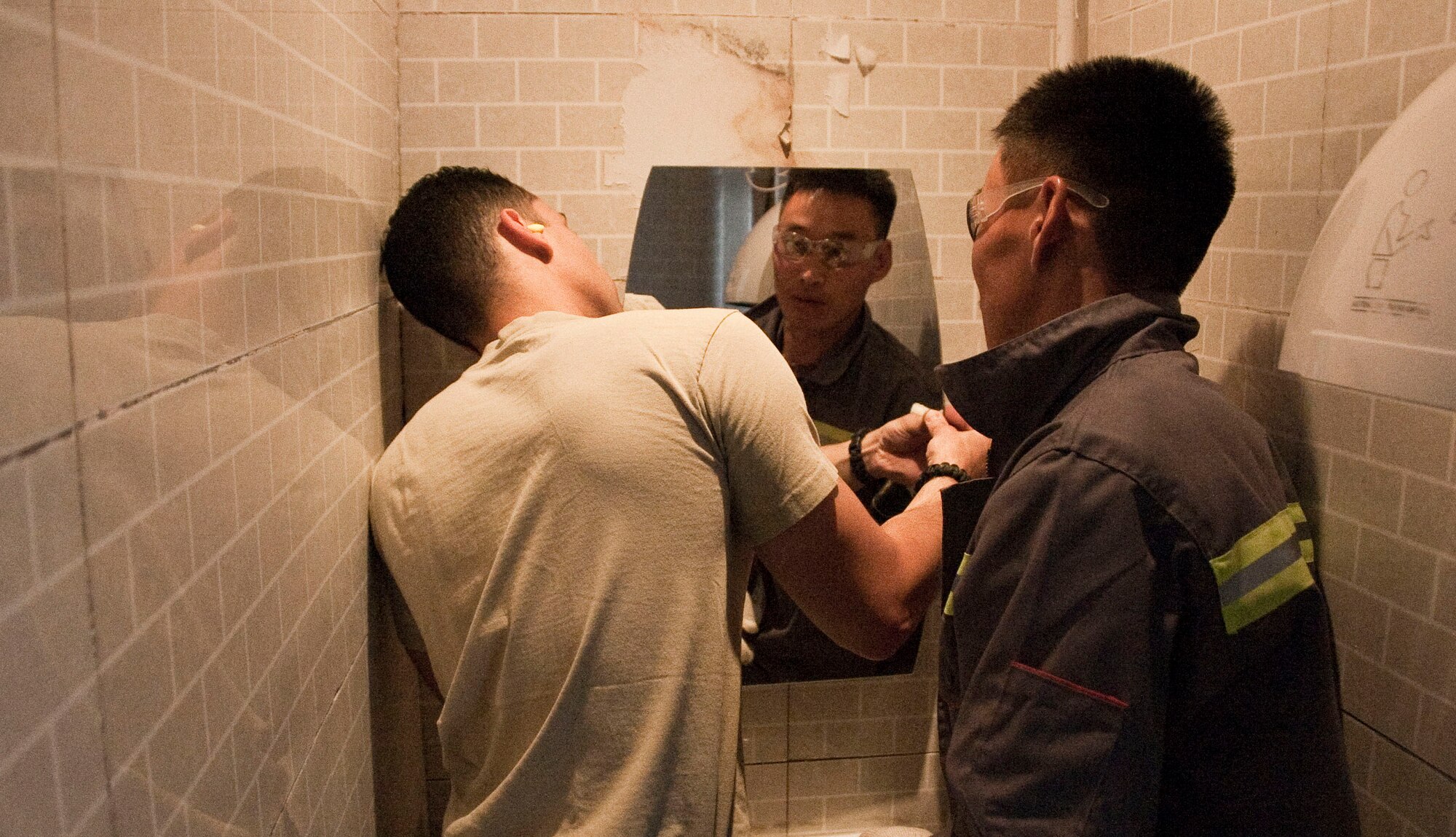 U.S. Air Force Staff Sgt. Christopher Villanueva, a structural engineer and carpenter, works with a Mongolian Armed Forces counterpart to install a mirror in a school in Erdenet, Mongolia, Aug. 12, 2014.  Operation Pacific Angel supports U.S. Pacific Command’s capacity-building efforts by partnering with other governments, non-governmental agencies and multilateral militaries in the respective region to provide medical, dental, optometry and engineering assistance to their citizens. (U.S. Air Force photo by Staff Sgt. William Banton/Released)