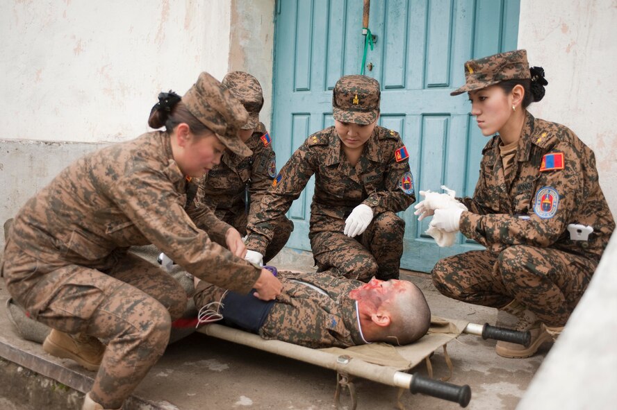 Mongolian Armed Forces first responders move victims during a during a mass-casualty response exercise as part of Operation Pacific Angel 14-4 Mongolia, Aug. 8 2014. Operation PACANGEL helps cultivate common bonds and fosters goodwill between the U.S., Mongolia and regional nations by conducting multilateral humanitarian assistance and civil military operations. (U.S. Air Force photo by Staff Sgt. William Banton/Released)