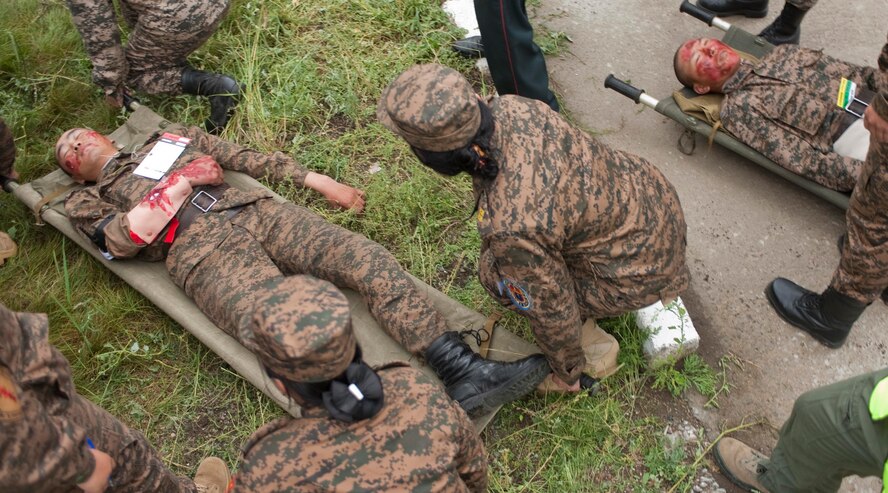 Mongolian Armed Forces first responders move victims during a during a mass-casualty response exercise as part of Operation Pacific Angel 14-4 Mongolia, Aug. 8 2014. Operation PACANGEL helps cultivate common bonds and fosters goodwill between the U.S., Mongolia and regional nations by conducting multilateral humanitarian assistance and civil military operations. (U.S. Air Force photo by Staff Sgt. William Banton/Released)