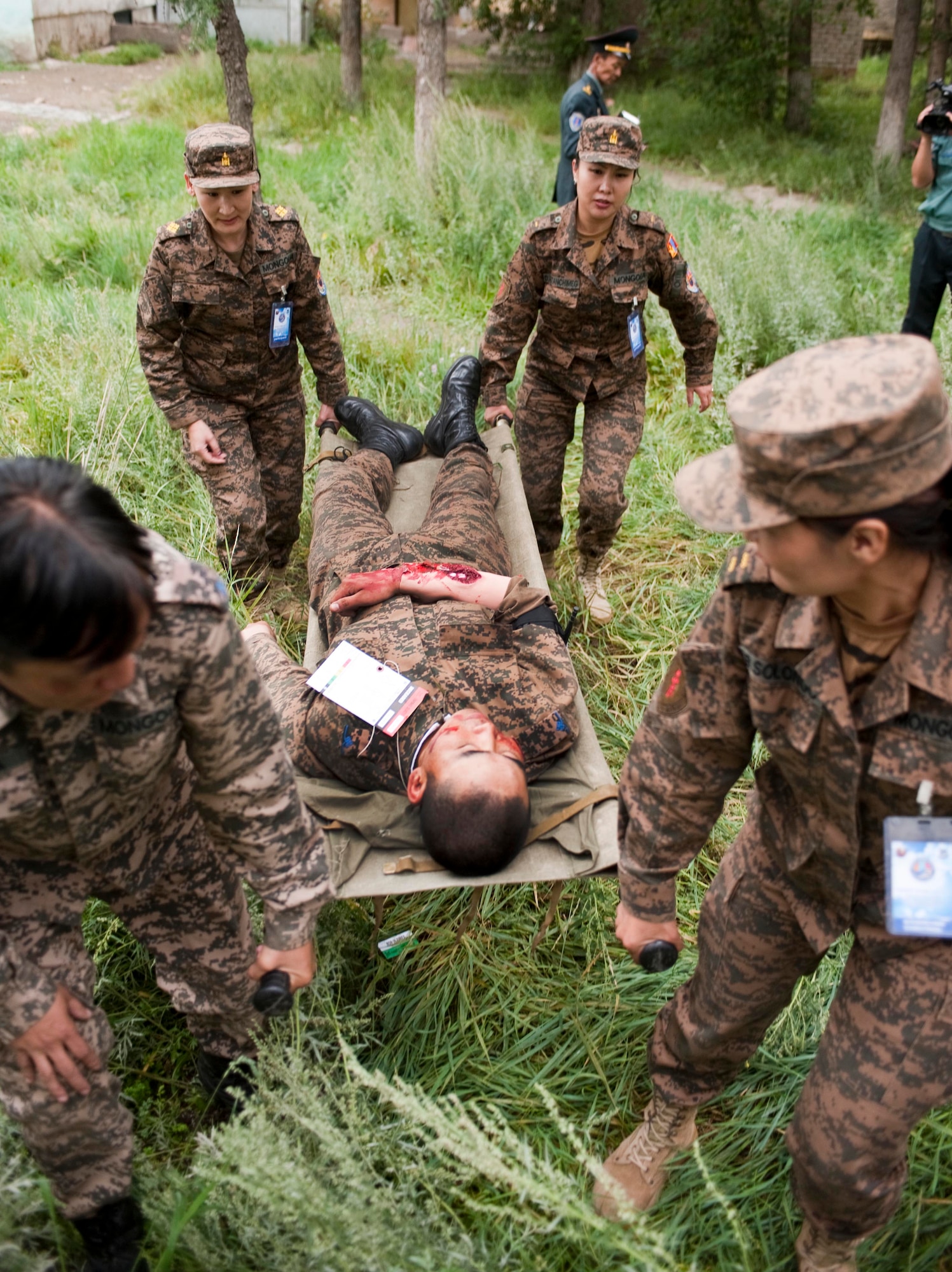 Mongolian Armed Forces first responders move victims during a during a mass-casualty response exercise as part of Operation Pacific Angel 14-4 Mongolia, Aug. 8 2014. Operation PACANGEL helps cultivate common bonds and fosters goodwill between the U.S., Mongolia and regional nations by conducting multilateral humanitarian assistance and civil military operations. (U.S. Air Force photo by Staff Sgt. William Banton/Released)