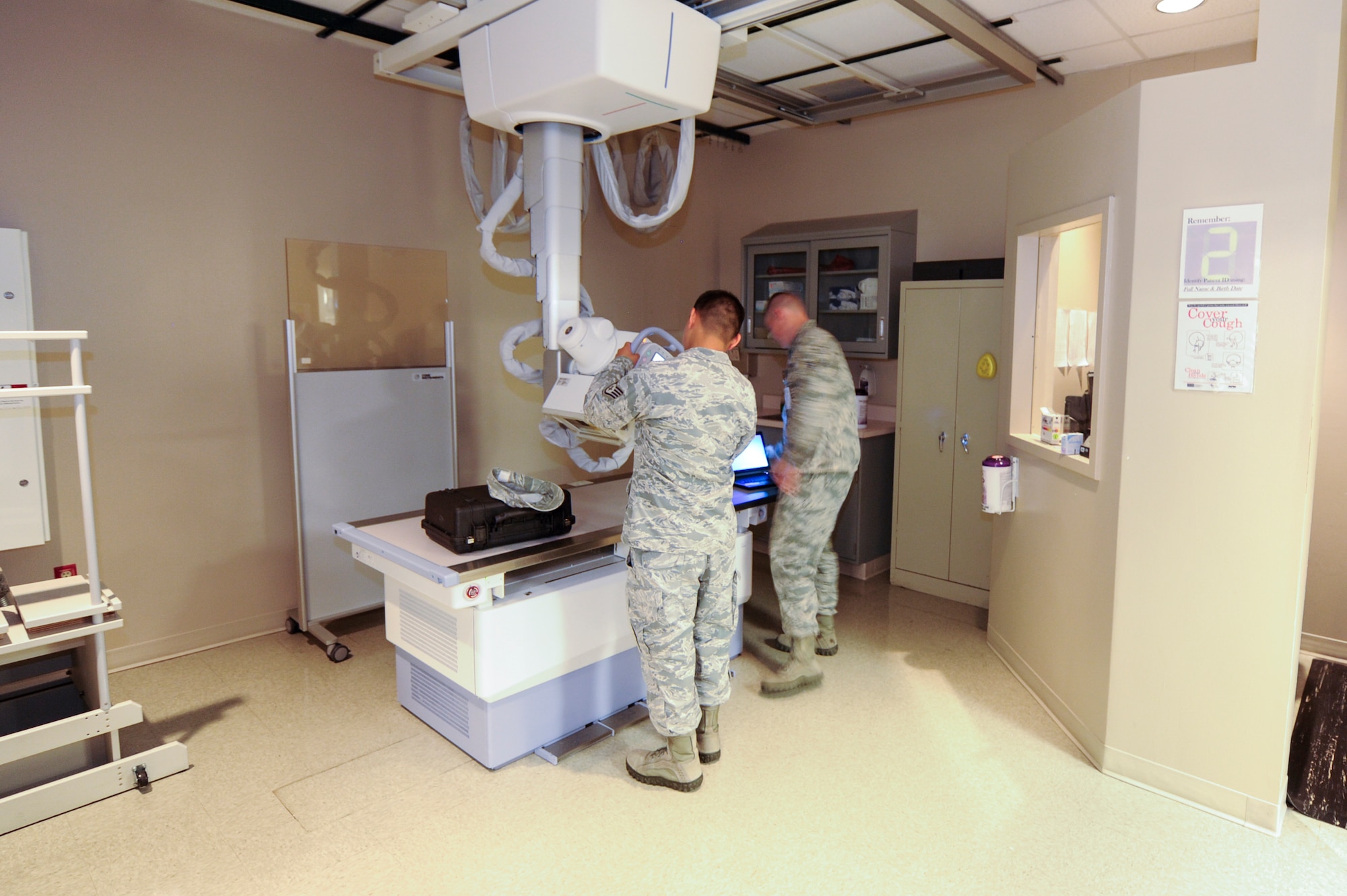 Biomedical Equipment Technicians maintain an X-ray machine at the 1st Special Operations Medical Group at Hurlburt Field Fla., Aug. 11, 2014. BMETs from the 1st Special Operations Medical Support Squadron maintain equipment ranging from blood pressure machines to X-ray machines used by the 1st SOMDG. (U.S. Air Force photo/Airman 1st Class Jeff Parkinson) 