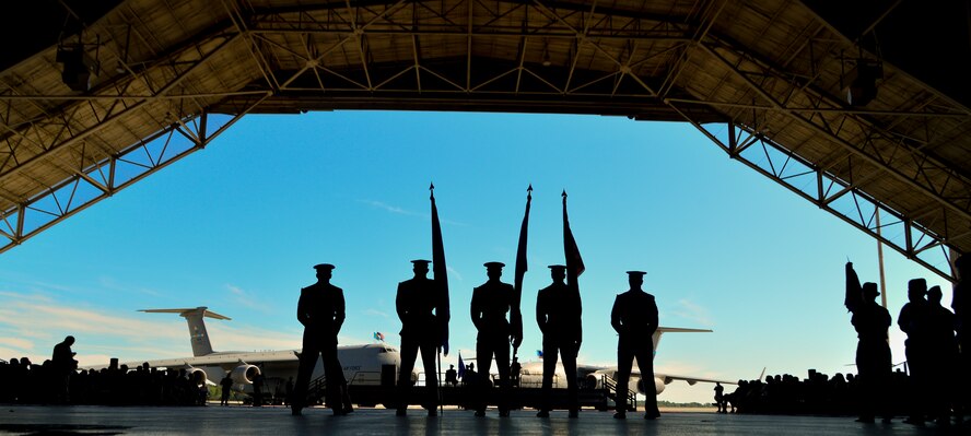 Members of the Dover Air Force Base Honor Guard stand by during a change of command ceremony Aug. 15, 2014, at Dover Air Force Base Del. Lt. Gen. Carlton D. Everhart II, 18th Air Force commander, presided over the ceremony where Col. Richard G. Moore  Jr., relinquished command of the 436th Airlift Wing to Col. Michael W. Grismer  Jr. (U.S. Air Force photo/Airman 1st Class William Johnson)