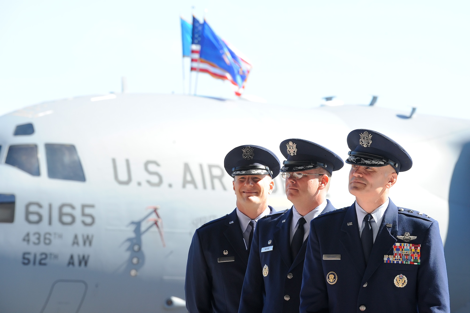 Senior officers wait before a change of command ceremony begins on Aug. 15, 2014, at Dover Air Force Base, Del. In the background is a C-17A Globemaster III 'Spirit of the Constitution' of the 436th Airlift Wing. From front to back are: Lt. Gen. Carlton D. Everhart II, 18th Air Force commander, Col. Richard G. Moore Jr. 436th AW outgoing commander and Col. Michael W. Grismer Jr., incoming 436th AW commander. (U.S. Air Force photo/Greg L. Davis) 