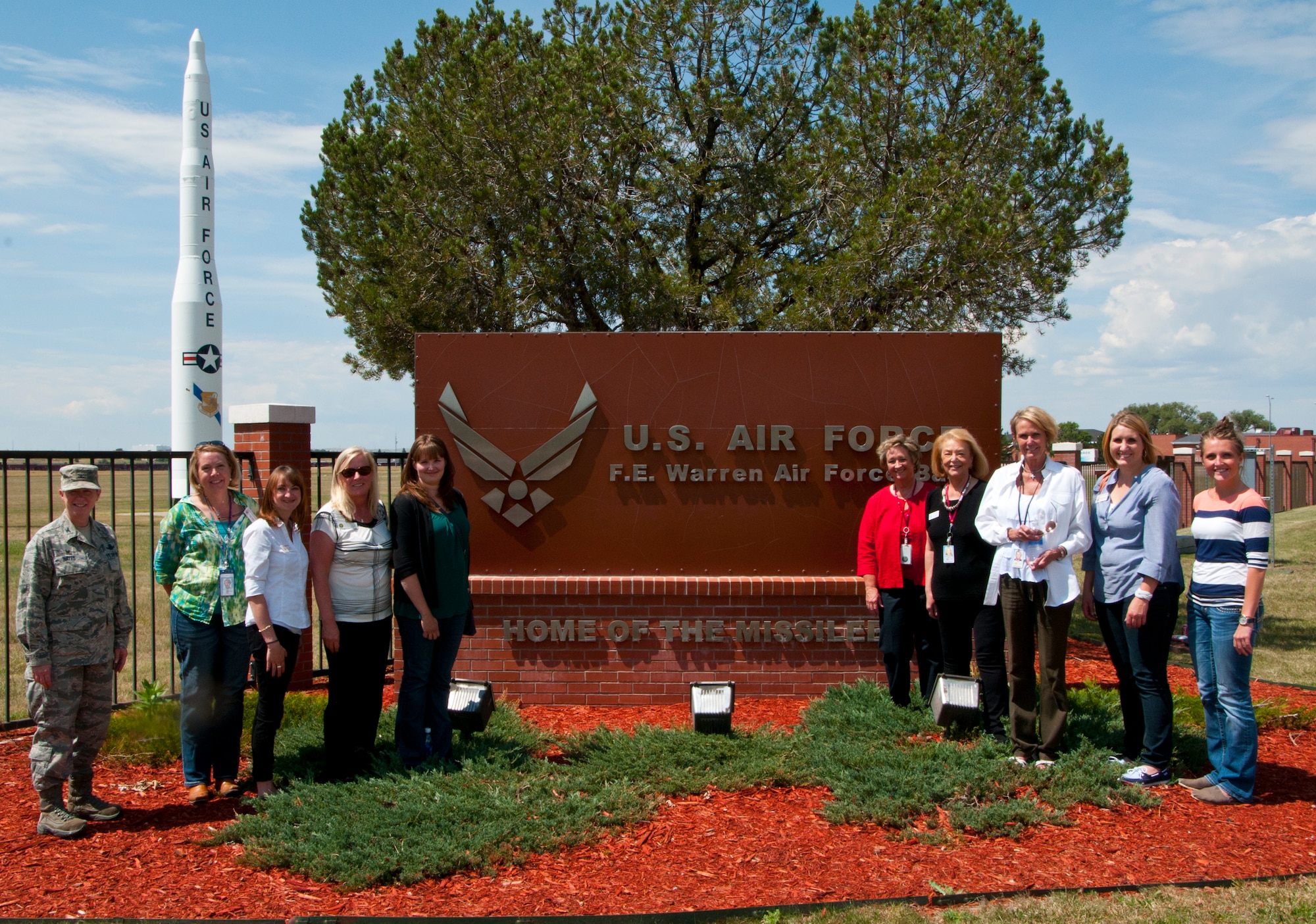 Col. Tracey Hayes, 90th Missile Wing commander, poses with a delegation of staff members from the offices of U.S. Congressmen outside Gate 1 Aug 13, 2014. The staff members toured F.E. Warren Air Force Base, Wyo., to familiarize themselves with Warren's mission, which takes place within Wyoming's borders and affects their constituent. (U.S. Air Force photo by Airman 1st Class Jason Wiese)