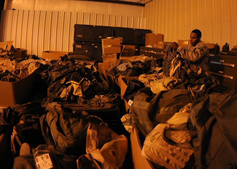 U.S. Air Force Senior Airman Trent Smith, 7th Logistics Readiness Squadron combat mobility journeyman, separates deployment gear Aug. 13, 2014, in the combat mobility warehouse at Dyess Air Force Base, Texas. Dyess Airmen who work in the warehouse are responsible for storing, inventorying, inspecting and issuing necessary deployment equipment to ensure serviceability. (U.S. Air Force photo by Senior Airman Shannon Hall/Released)