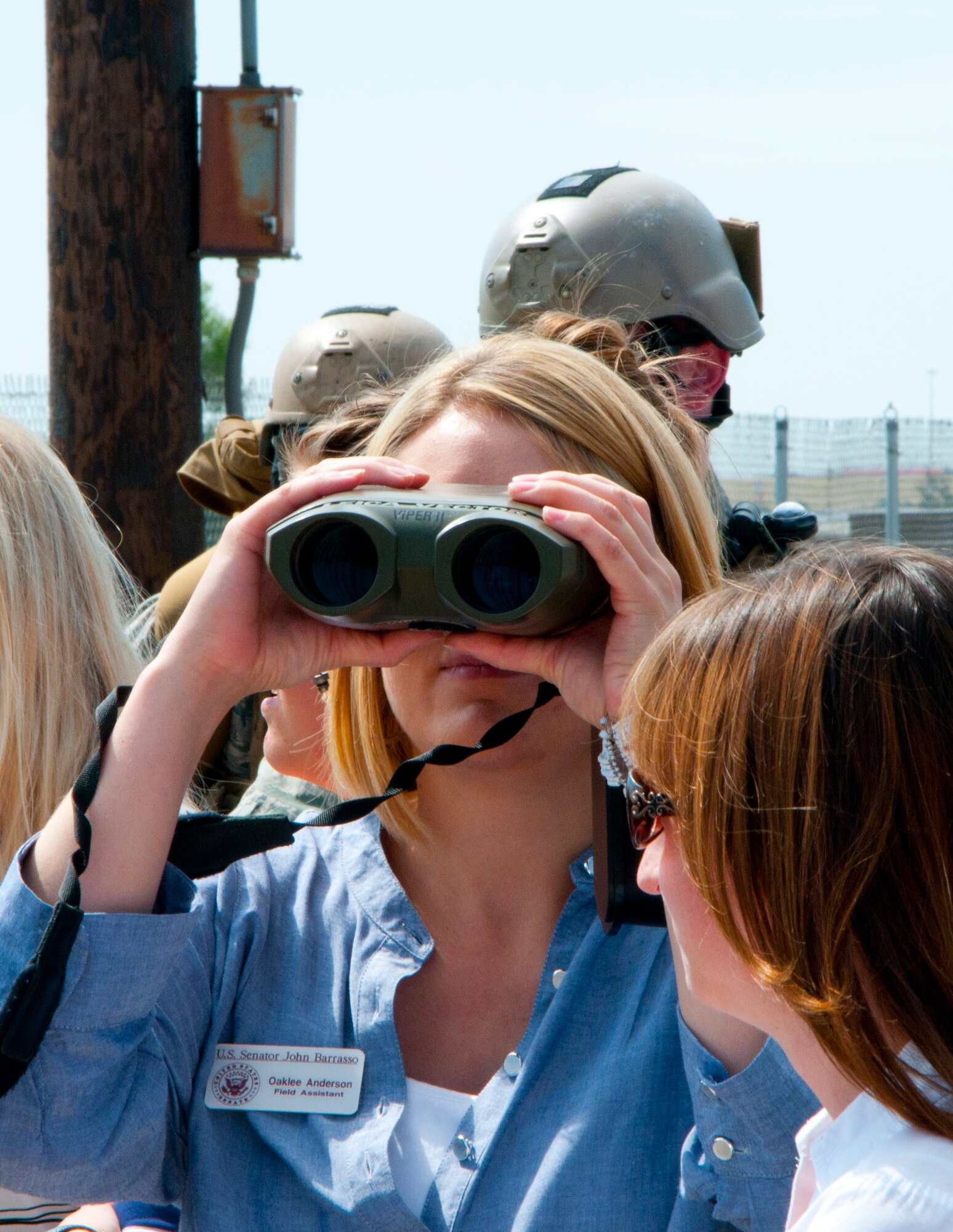 Oaklee Anderson, U.S. Sen. John Barasso’s field assistant, looks through a pair of binoculars used by the 90th Security Forces Group Tactical Response Force at the U-02 training site Aug. 13, 2014, during a tour she and other congressional staff members took of F.E. Warren Air Force Base, Wyo. The staff viewed displays of equipment from the 90th and 790th Missile Security Forces Squadrons. (U.S. Air Force photo by Airman 1st Class Jason Wiese)