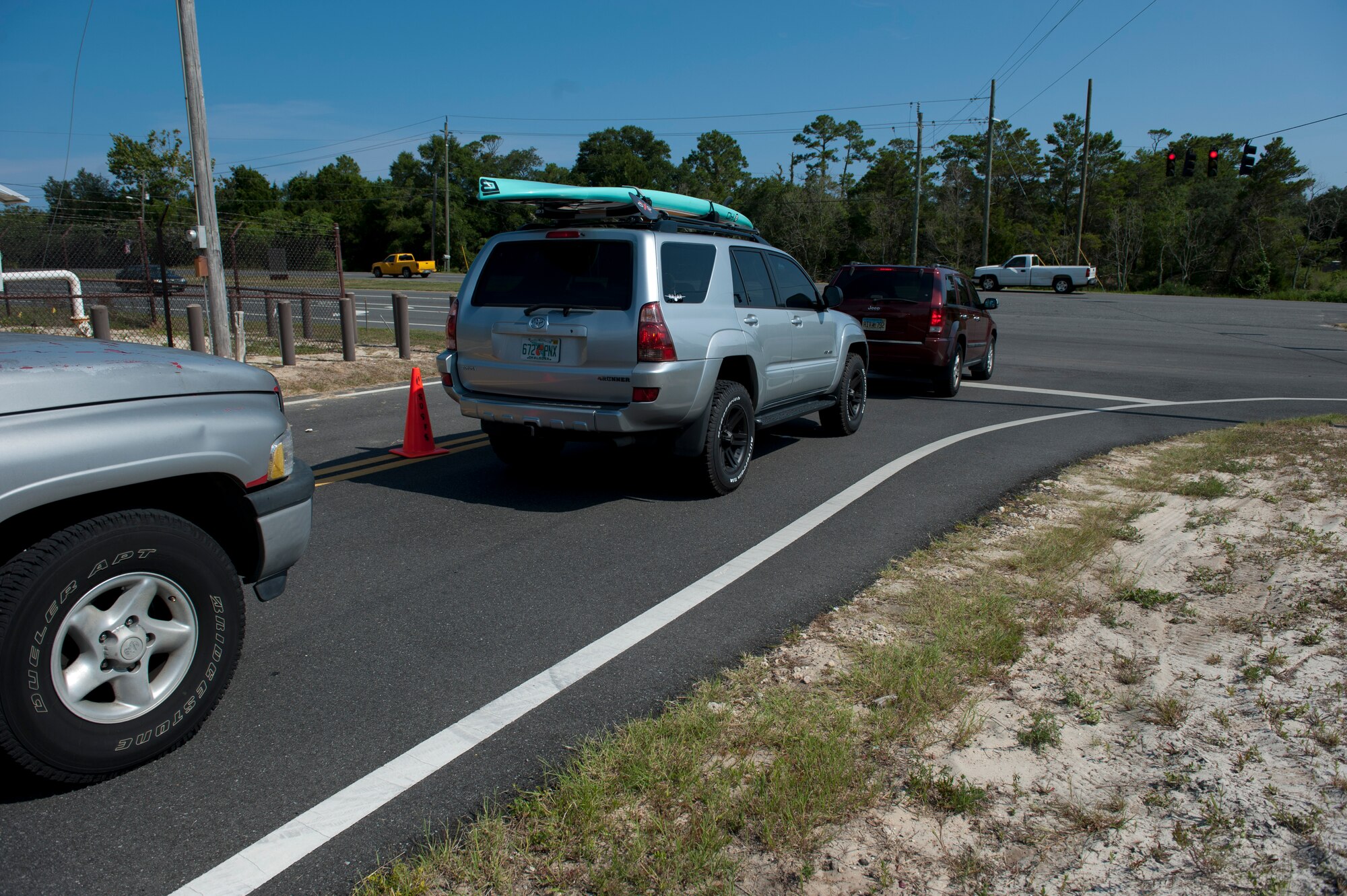 Cars wait to turn onto U.S. Highway 98 at the Kerwood Gate on Hurlburt Field, Fla., Aug. 8, 2014. The traffic light at the gate allows vehicles to exit the installation and go either westbound or eastbound onto U.S. Highway 98. (U.S. Air Force photo/Senior Airman Krystal Garrett)