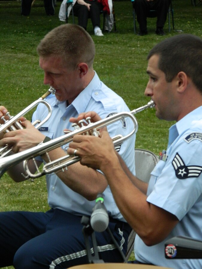 Senior Airman Jeremy Carles and Senior Airman Carl Stanley perform with Brass in Blue during a concert on July 2, 2014 in Sterling, MA.  Brass in Blue quickly adjusted to changing weather conditions and provided a patriotic concert to the crowd before severe weather struck.  (U.S. Air Force Photo/Technical Sgt. Dawn Hoffman)