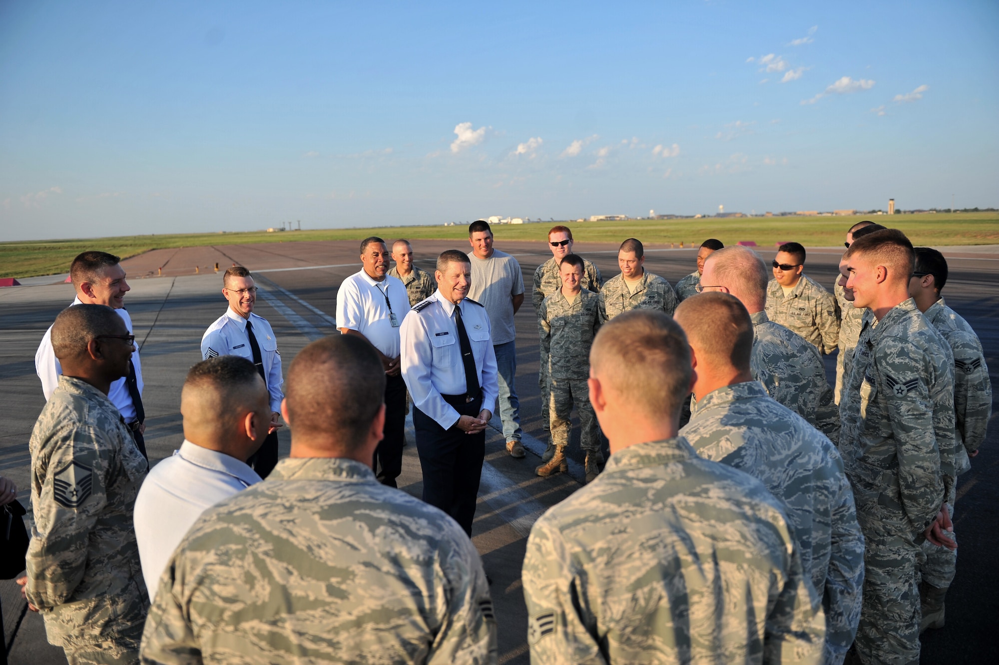 ALTUS AIR FORCE BASE, Okla. – U.S. Air Force Gen. Robin Rand, commander of Air Education and Training Command, speaks to Airmen of the 97th Civil Engineer Squadron during a demonstration of the in-house rubber removal process on the flightline Aug. 7, 2014. Rand spoke to the Airmen about current Air Force topics and encouraged them to keep up the good work. (U.S. Air Force photo by Senior Airman Dillon Davis/Released)