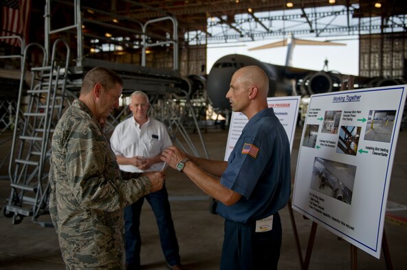 ALTUS AIR FORCE BASE, Okla. – U.S. Air Force Gen. Robin Rand, commander of Air Education and Training Command, speaks to David Dresser, 97th Maintenance Directorate, about Altus’ Voluntary Protection Program during a visit to the maintenance hangar Aug. 6, 2014. Dresser explained in detail what the program has done to improve the safety and efficiency of the base’s maintainers. (U.S. Air Force photo by Senior Airman Dillon Davis/Released)