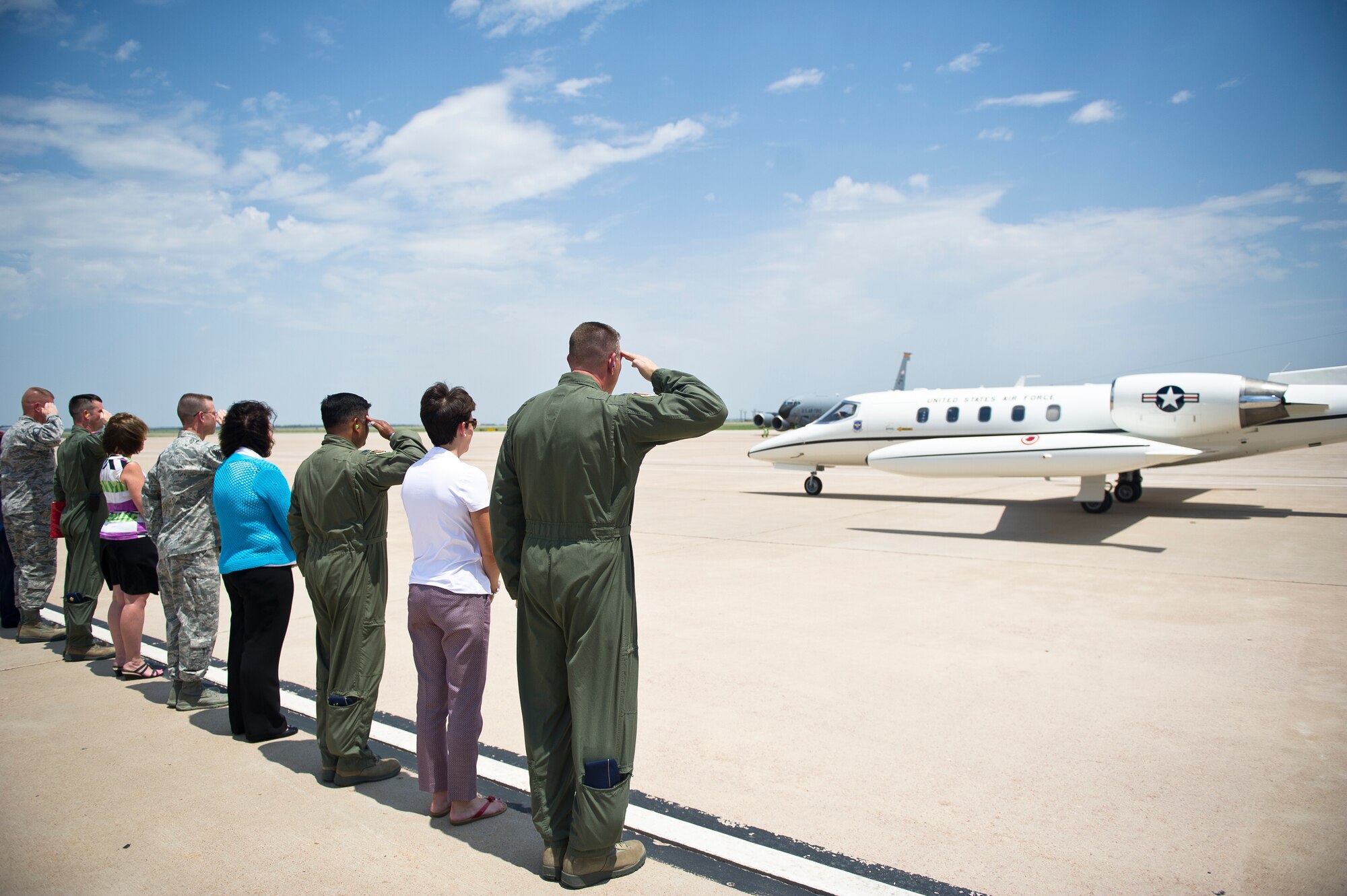 ALTUS AIR FORCE BASE, Okla. – Leaders of the 97th Air Mobility Wing salute the aircraft transporting U.S. Air Force Gen. Robin Rand, commander of Air Education and Training Command, as he arrives on the flightline Aug. 6, 2014. During the visit, Rand, Mrs. Rand and U.S. Air Force Chief Master Sgt. Gerardo Tapia, AETC command chief, were able to see Altus AFB and meet some of the top performing Airmen. (U.S. Air Force photo by Senior Airman Dillon Davis/Released)