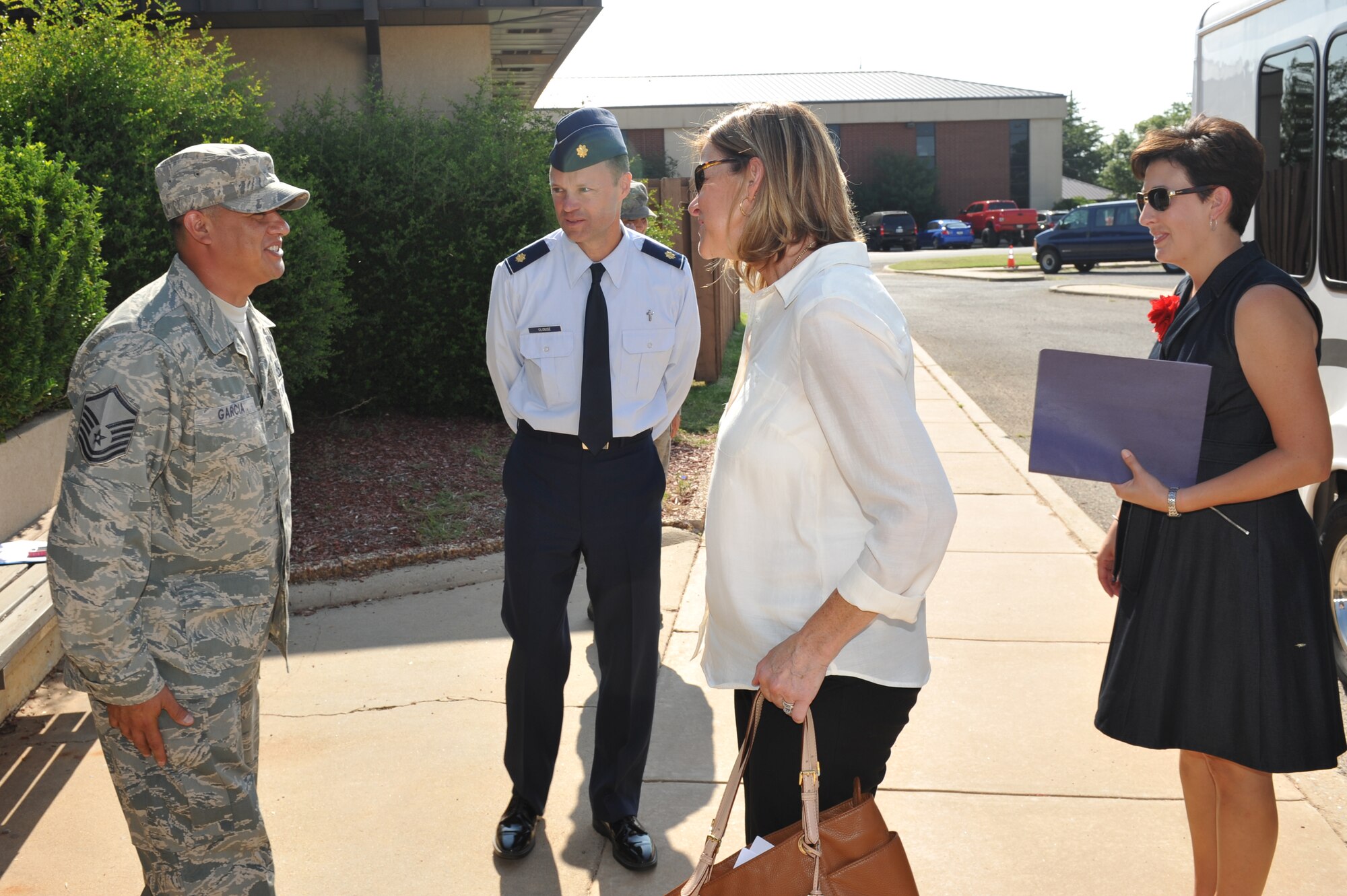 ALTUS AIR FORCE BASE, Okla. – U.S. Air Force Master Sgt. Jason Garcia, 97th Air Mobility Wing Chapel assistant, and U.S. Air Force Maj. Bryan Clouse, 97th Air Mobility Wing chaplain, greet Mrs. Kim Rand, spouse of Gen. Robin Rand, commander of Air Education and Training Command, and Mrs. Alisa Spangenthal, spouse of the 97th AMW commander, at the Airmen Resiliency Center during Rand’s tour Aug. 7, 2014. Clouse and Garcia informed Rand of some of the great things that the ARC is doing for Airmen including the Airmen’s Pantry and Airmen’s Attic. (U.S. Air Force photo by Airman 1st Class J. Zuriel Lee/Released)