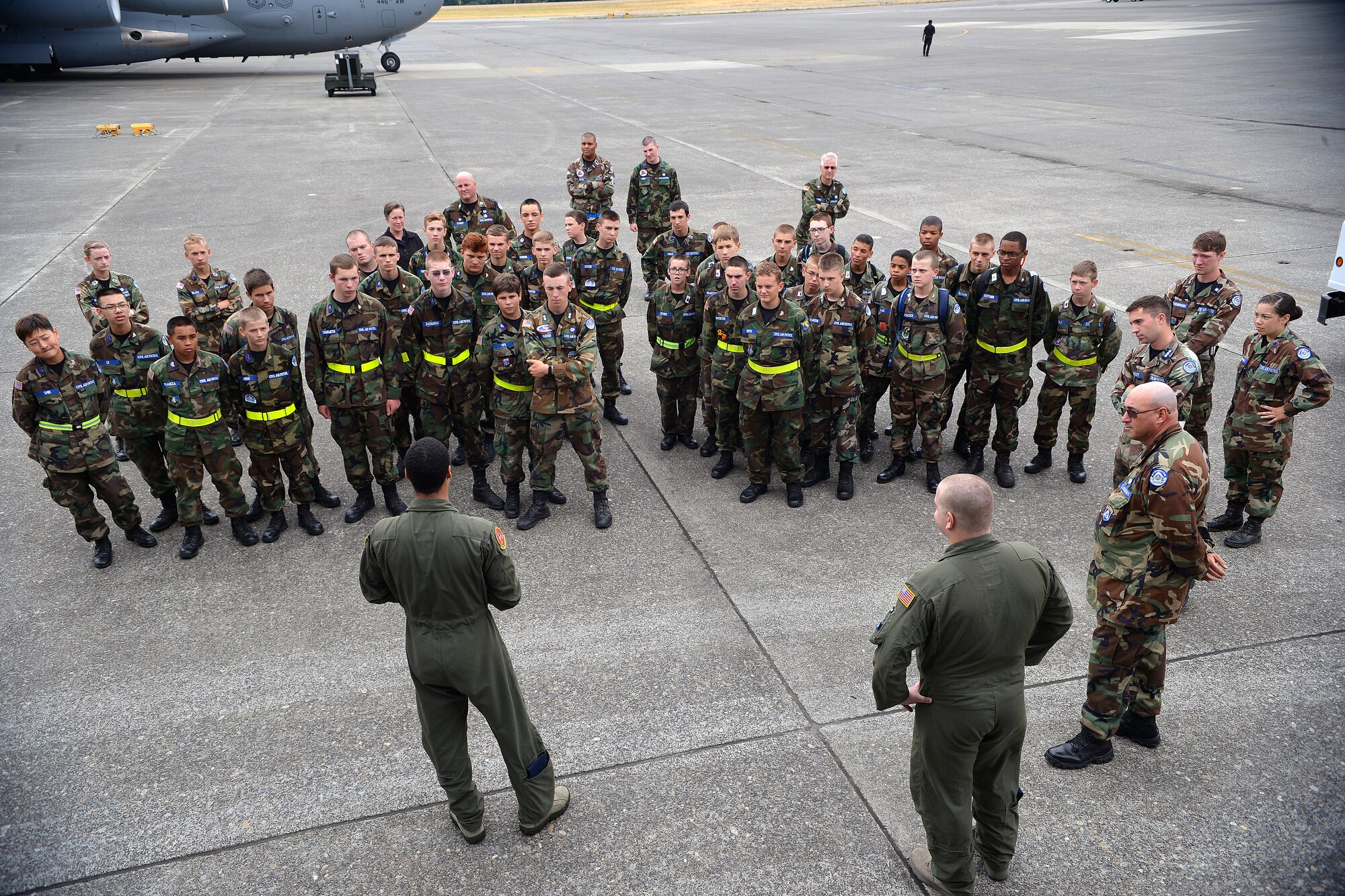 Senior Airman Ryan Kelly, left, 10th Airlift Squadron loadmaster, briefs members of the Civil Air Patrol prior to boarding a C-17 Globemaster III Aug. 13, 2014, at Joint Base Lewis-McChord, Wash. The Civil Air Patrol is a non-profit civilian counterpart to the United States Air Force. (U.S. Air Force photo/Airman 1st Class Keoni Chavarria)