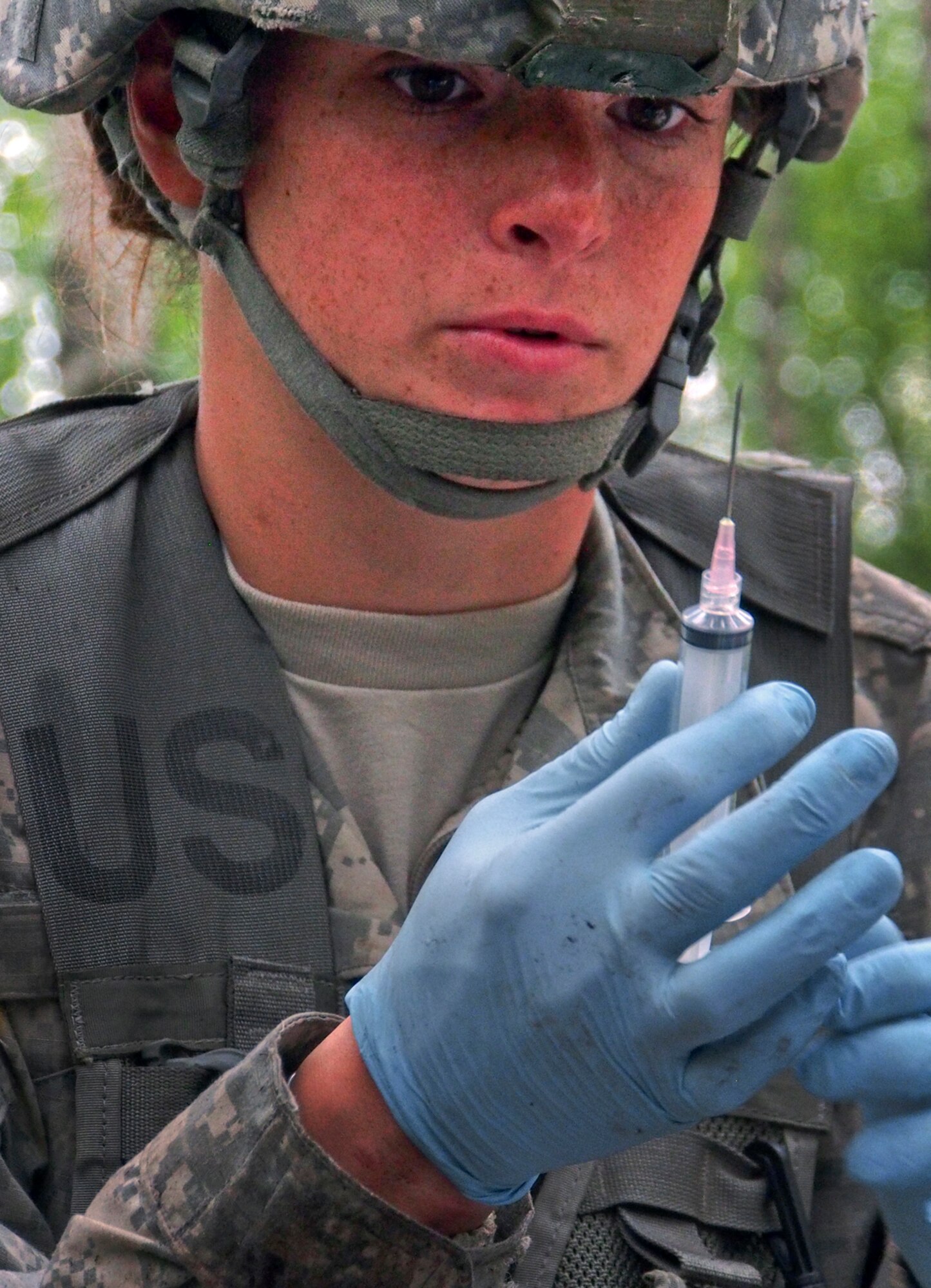 Army 2nd Lt. Kaitlyn Haines, assigned to C Company, 725th Brigade Support Battalion (Airborne), 4th Infantry Brigade Combat Team (Airborne), 25th Infantry Division, U.S. Army Alaska, performs a task on the Tactical Combat Casualty Care Lane during Expert Field Medical Badge testing on Joint Base Elmendorf-Richardson, Alaska, Wednesday, Aug. 13, 2014. The Expert Field Medical Badge is a U.S. Army decoration dating back to 1965, and is the non-combat equivalent of the Combat Medical Badge. Individuals who successfully complete the EFMB course written and performance tests constitute approximately less than 20% of those who begin it. (U.S. Air Force photo/Justin Connaher)