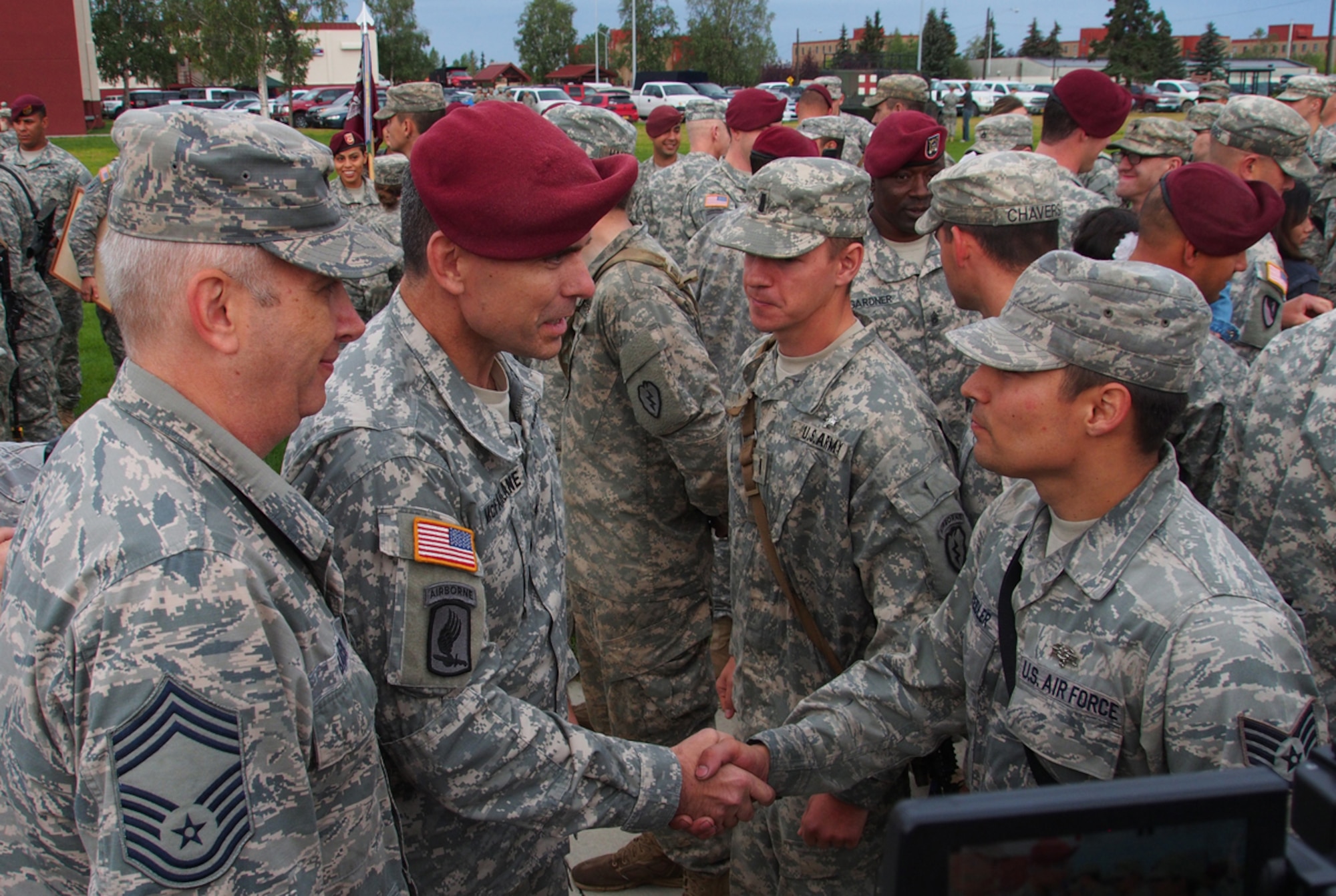 Chief Master Sgt. Richard Baker, 673d Medical Group, left, and Army Col. Matt McFarlane, 4th Infantry Brigade Combat Team (Airborne) commander, congratulate Air Force Staff Sgt. Stephen Kreitler, a native of Napavine, Wash., assigned to 673d Medical Group, after he is awarded the Expert Field Medical Badge on Joint Base Elmendorf-Richardson, Alaska, Thursday, Aug. 14, 2014. The Expert Field Medical Badge is a U.S. Army decoration dating back to 1965, and is the non-combat equivalent of the Combat Medical Badge. Individuals who successfully complete the EFMB course written and performance tests constitute approximately less than 20% of those who begin it. (U.S. Air Force photo/Justin Connaher)