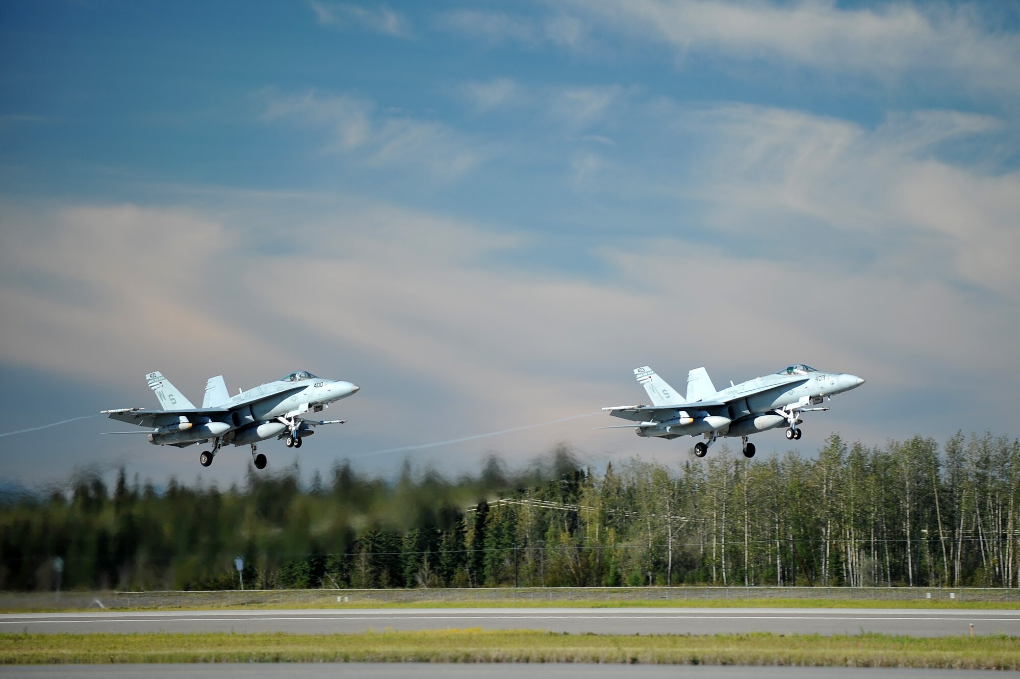 U.S. Marine Corps F/A-18C Hornets assigned to the Marine Fighter Attack Squadron 323, Marine Corps Air Station Miramar, Calif., take off during RED FLAG-Alaska 14-3 Aug. 14, 2014, Eielson Air Force Base, Alaska. The Hornet is designed for strike applications such as interdiction and close air support without compromising fighter capabilities. (U.S. Air Force photo by Staff Sgt. Jim Araos/Released)