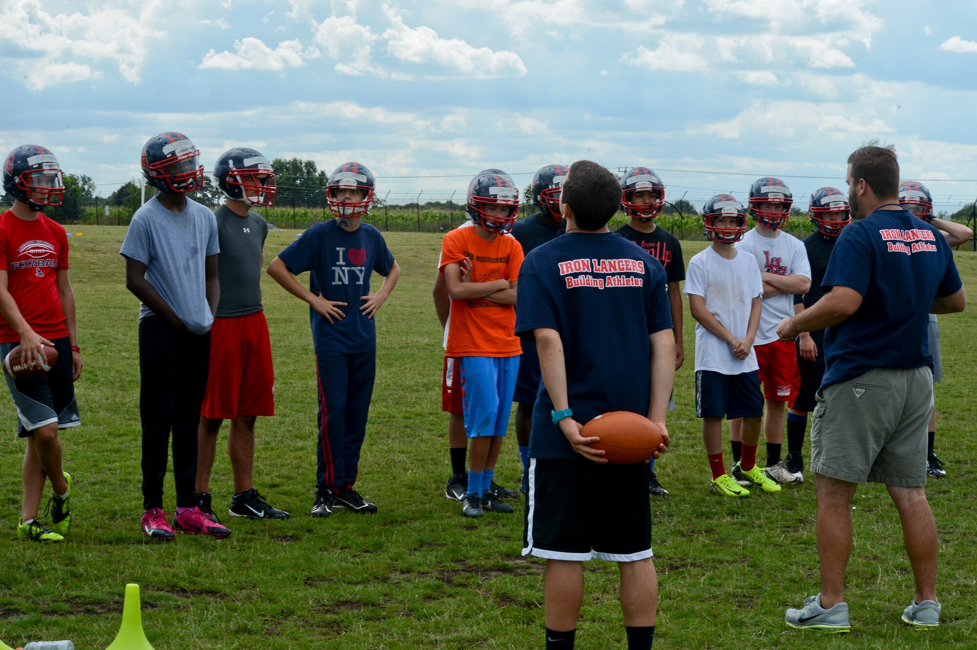 Lakenheath High School football players listen to coaching points given by Steve Noble, right, Lakenheath High School football team defensive coach, at Royal Air Force Lakenheath, England, Aug. 13, 2014. With the 2014-2015 football season underway, the Lakenheath Lancers look to make steps in the right direction for the program. Noble stated, “I have some great young men who have put in hard work throughout the summer workouts, and I can tell they’re hungry.” (U.S. Air Force photo by Airman 1st Class Trevor T. McBride)