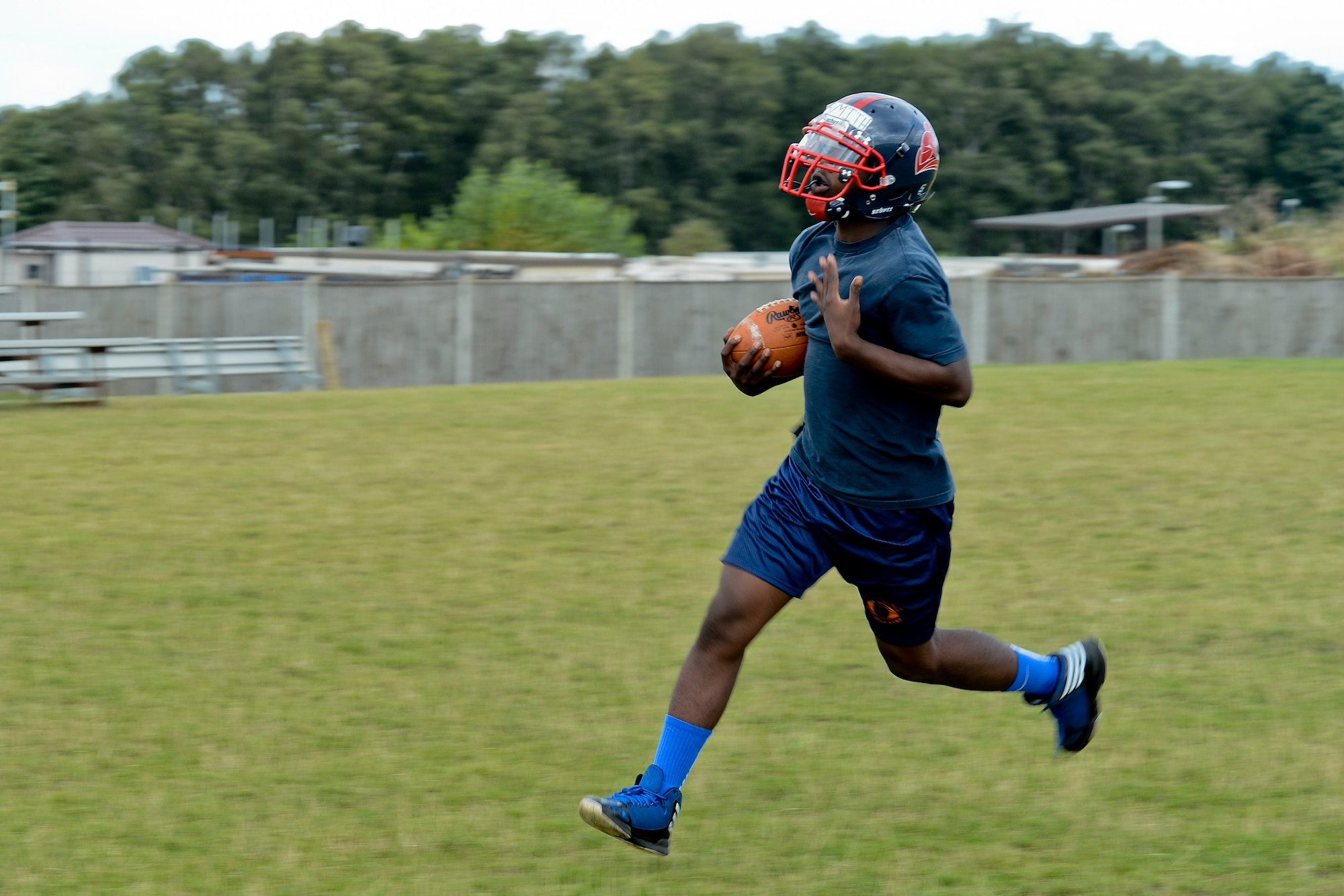 Marcus Smith, Lakenheath High School football team fullback, runs the ball during practice at Royal Air Force Lakenheath, England, Aug. 13, 2014. With the 2014-2015 football season underway, the Lakenheath Lancers look to make steps in the right direction for the program.  (U.S. Air Force photo by Airman 1st Class Trevor T. McBride)