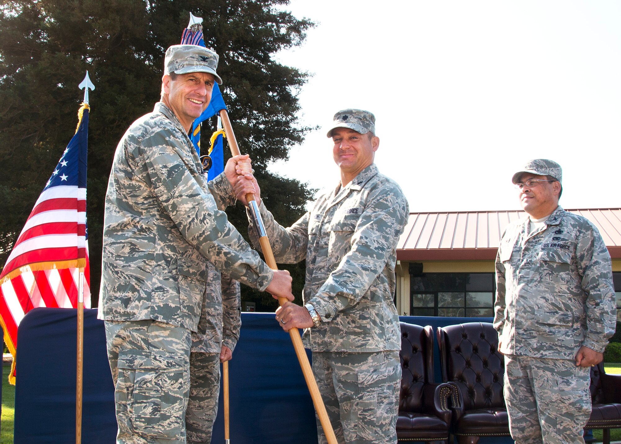 Col. Corey Martin, left, 60th Air Mobility Wing commander, passes the 60th Mission Support Group guidon to Lt. Col. George Dietrich as he assumes command of the group Aug. 8 at Travis Air Force Base. (U.S. Air Force photo/T.C. Perkins Jr.)