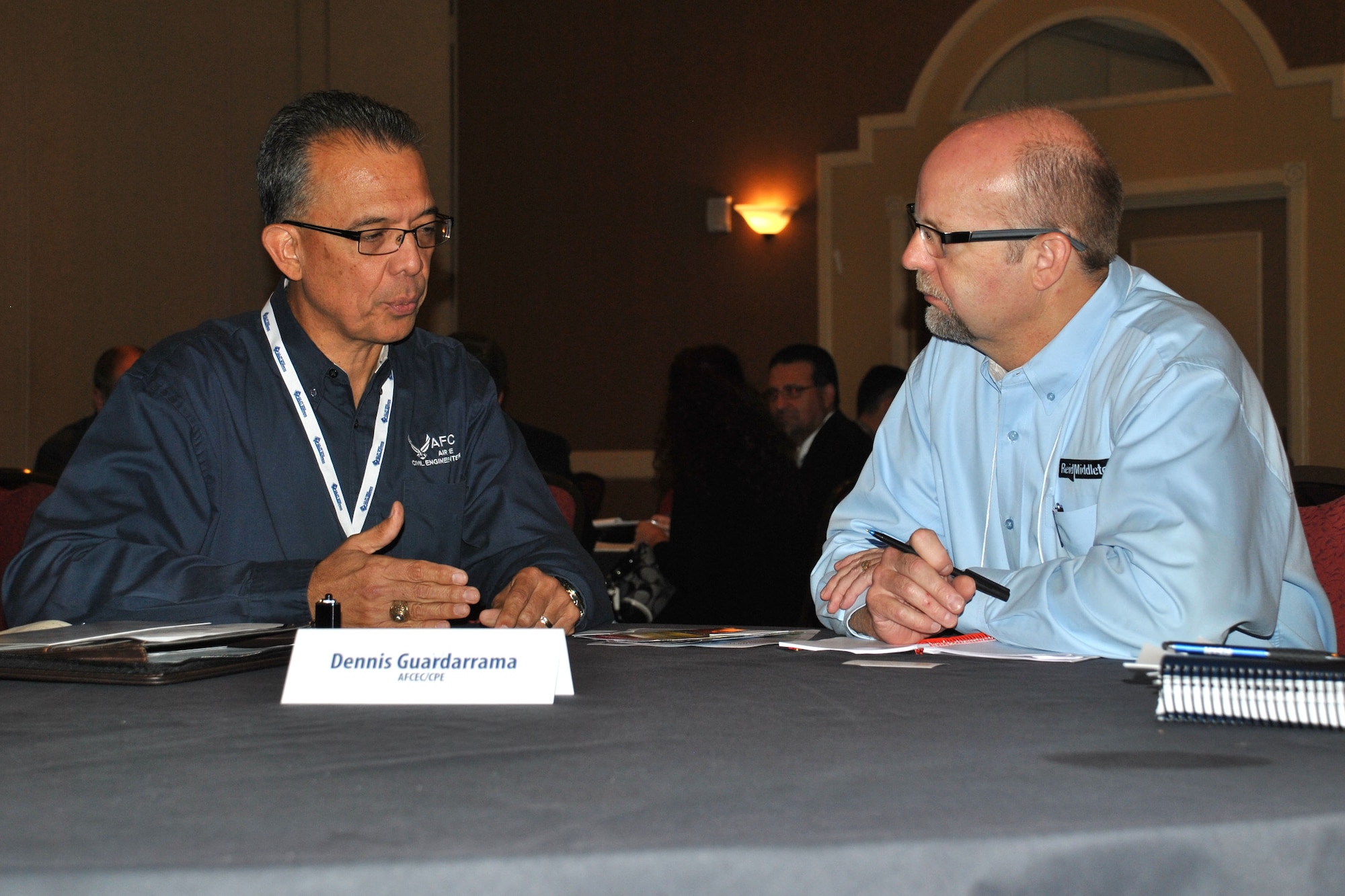 At left, Dennis Guadarrama, answers Robert Galteland’s questions about future business opportunities  with AFCEC during the 2014 SAME Small Business Market Research Fair Aug. 14 in San Antonio. The event included opportunities for small business contractors to talk one-on-one with federal agency leaders and key subject matter experts. Guadarrama is chief of the enterprise and procurement division for AFCEC’s Planning and Integration Directorate. (U.S. Air Force photo/Shannon Carabajal/Released)
