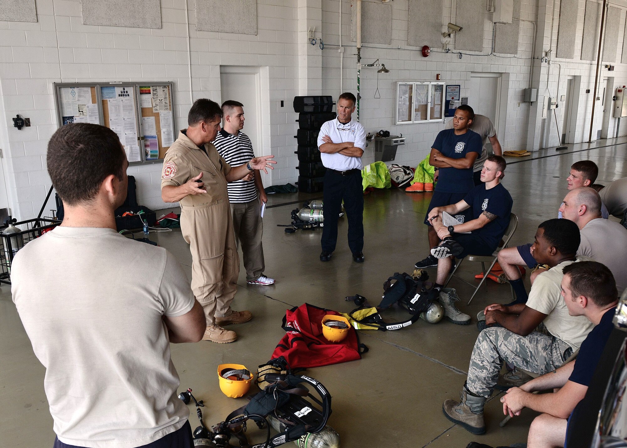 U.S. Service members are debriefed after a simulated exercise during a two-week Hazardous Material Awareness and Operations Training Course at Langley Air Force Base, Va., Aug. 13, 2014.  A total of 12 students were trained and certified from four installations including Langley, Ellsworth and Andrews Air Force Bases as well as Elizabeth City, N.C. Coast Guard members. (U.S. Air Force photo by Senior Airman Connor Estes/Released)
