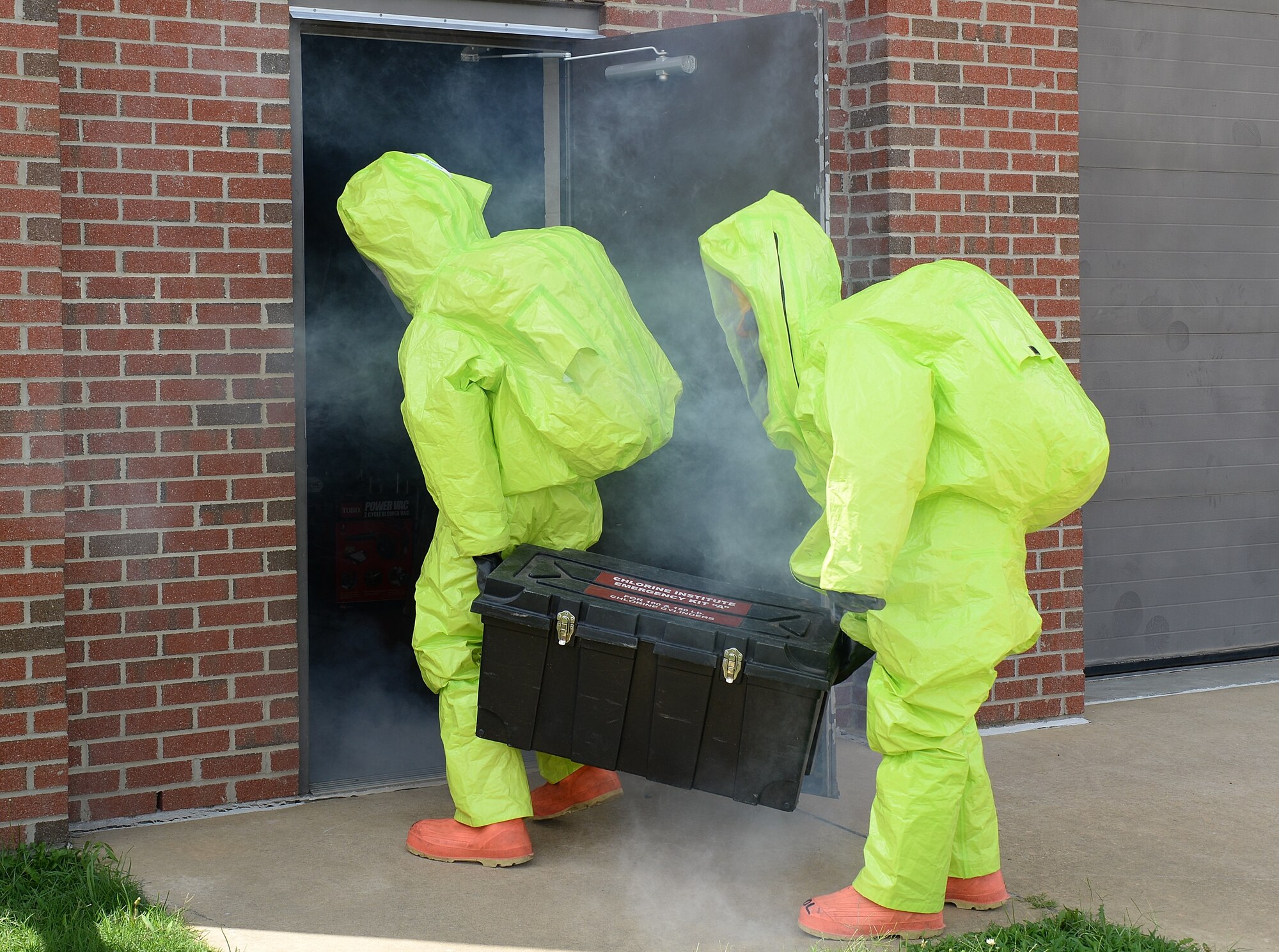 U.S. Service members train to suppress a chlorine vapor leak during a Hazardous Materials Awareness and Operations course at Langley Air Force Base, Va., Aug. 13, 2014. Students learned how to work with certain types of HAZMAT containers as well as performing operations in a Vapor-tight HAZMAT suit. (U.S. Air Force photo by Senior Airman Connor Estes/Released)