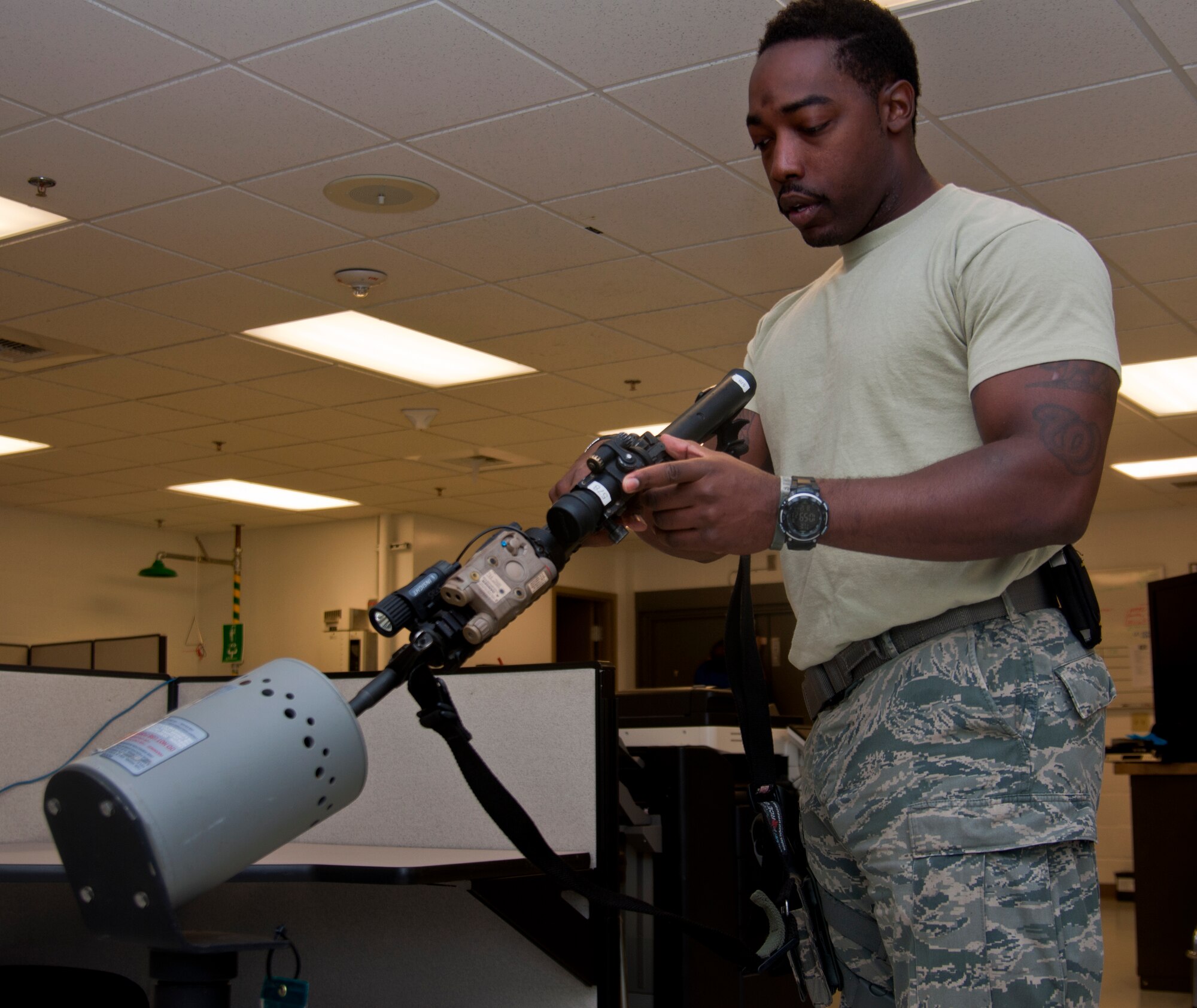Senior Airman Akeem Washington, 573rd Global Support Squadron, simulates clearing an M4 Carbine Rifle August 13, 2014. Washington recently became just the third Airman in Air Mobility Command to achieve the ‘Warrior’ status in the command’s Leadership Pathways program. (U.S. Air Force photo by Senior Airman Charles Rivezzo)