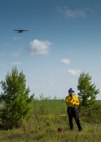 CJ Mahon, a Jackson Guard firefighter, talks on the radio as a C-145 takes off from the Duke Field runway. The members of Jackson Guard’s wildland fire center are responsible for controlling and maintaining Eglin’s natural resources and operations areas through controlled burning of the it’s forests.  (U.S. Air Force photo/Tech. Sgt. Jasmin Taylor)