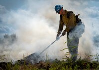 Aaron Radford, a Jackson Guard firefighter, works to put out a smoldering fire after a recent exercise at Duke Field Fla.  The members of Jackson Guard’s wildland fire center are responsible for controlling and maintaining Eglin’s natural resources and operations areas through controlled burning of the it’s forests.  (U.S. Air Force photo/Tech. Sgt. Jasmin Taylor)
