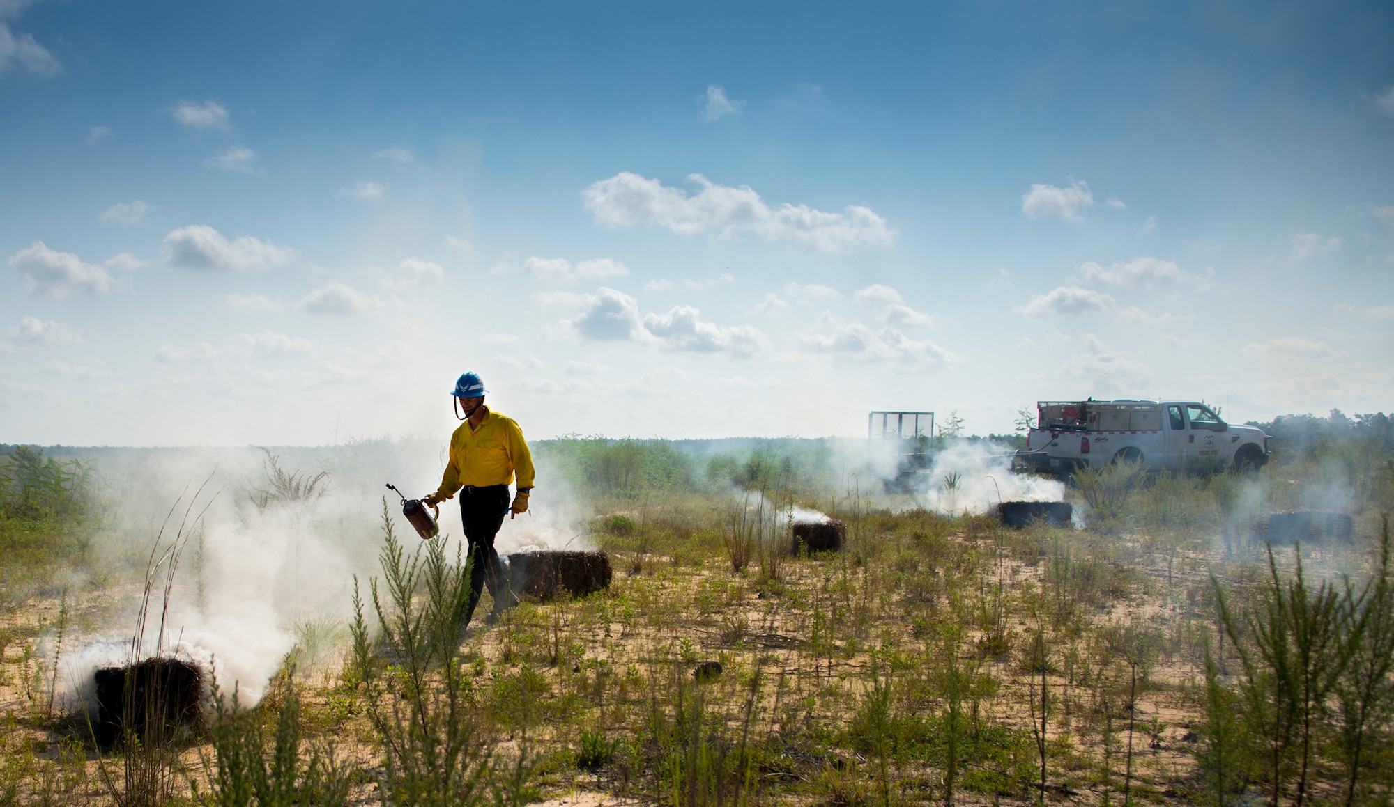 CJ Mahon, a Jackson Guard firefighter, lights hay on fire for a recent exercise at Duke Field Fla.  The members of Jackson Guard’s wildland fire center are responsible for controlling and maintaining Eglin’s natural resources and operations areas through controlled burning of the it’s forests.  (U.S. Air Force photo/Tech. Sgt. Jasmin Taylor)
