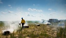 CJ Mahon, a Jackson Guard firefighter, lights hay on fire for a recent exercise at Duke Field Fla.  The members of Jackson Guard’s wildland fire center are responsible for controlling and maintaining Eglin’s natural resources and operations areas through controlled burning of the it’s forests.  (U.S. Air Force photo/Tech. Sgt. Jasmin Taylor)